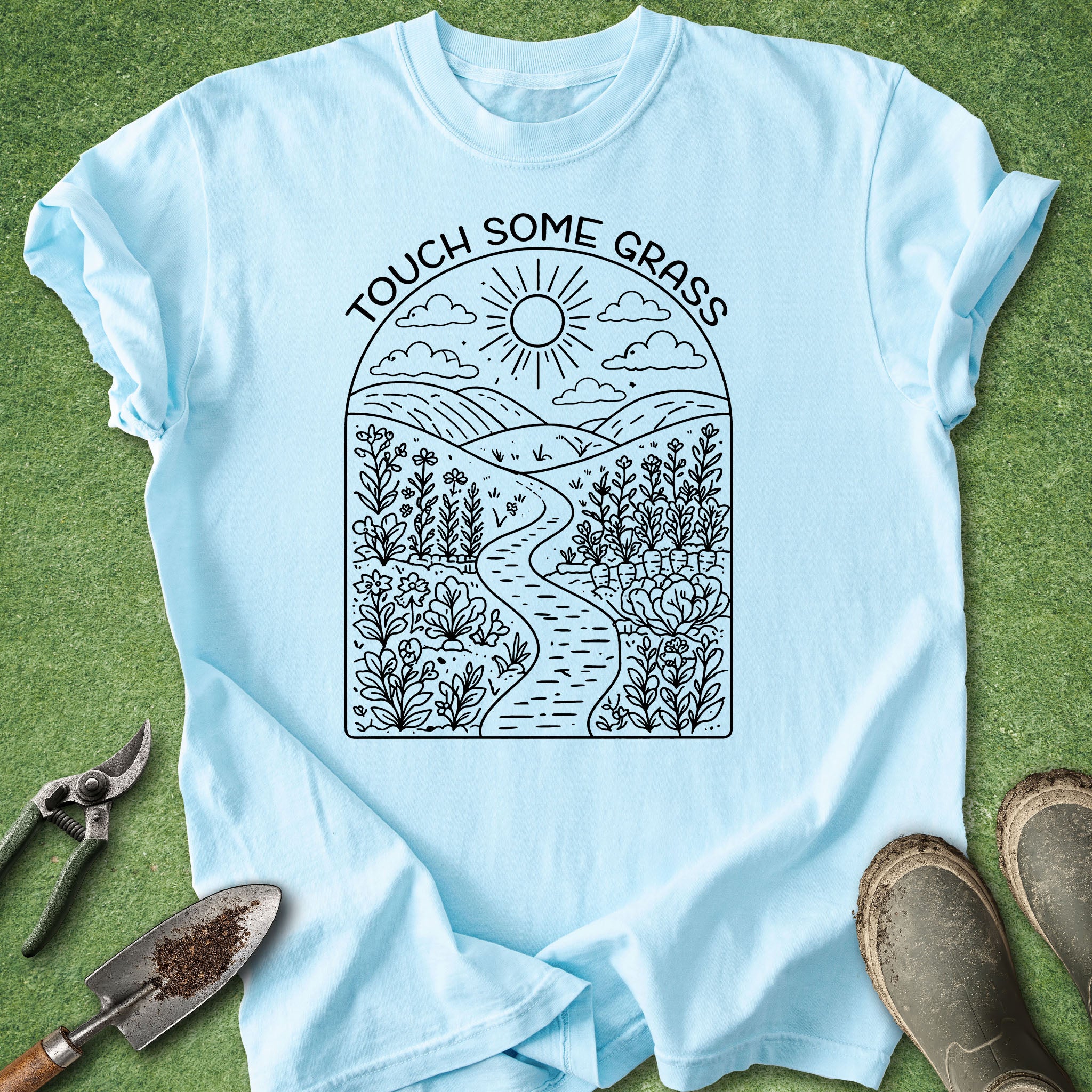 Light blue t-shirt with nature-themed design and 'Touch Some Grass' text on a grass background.