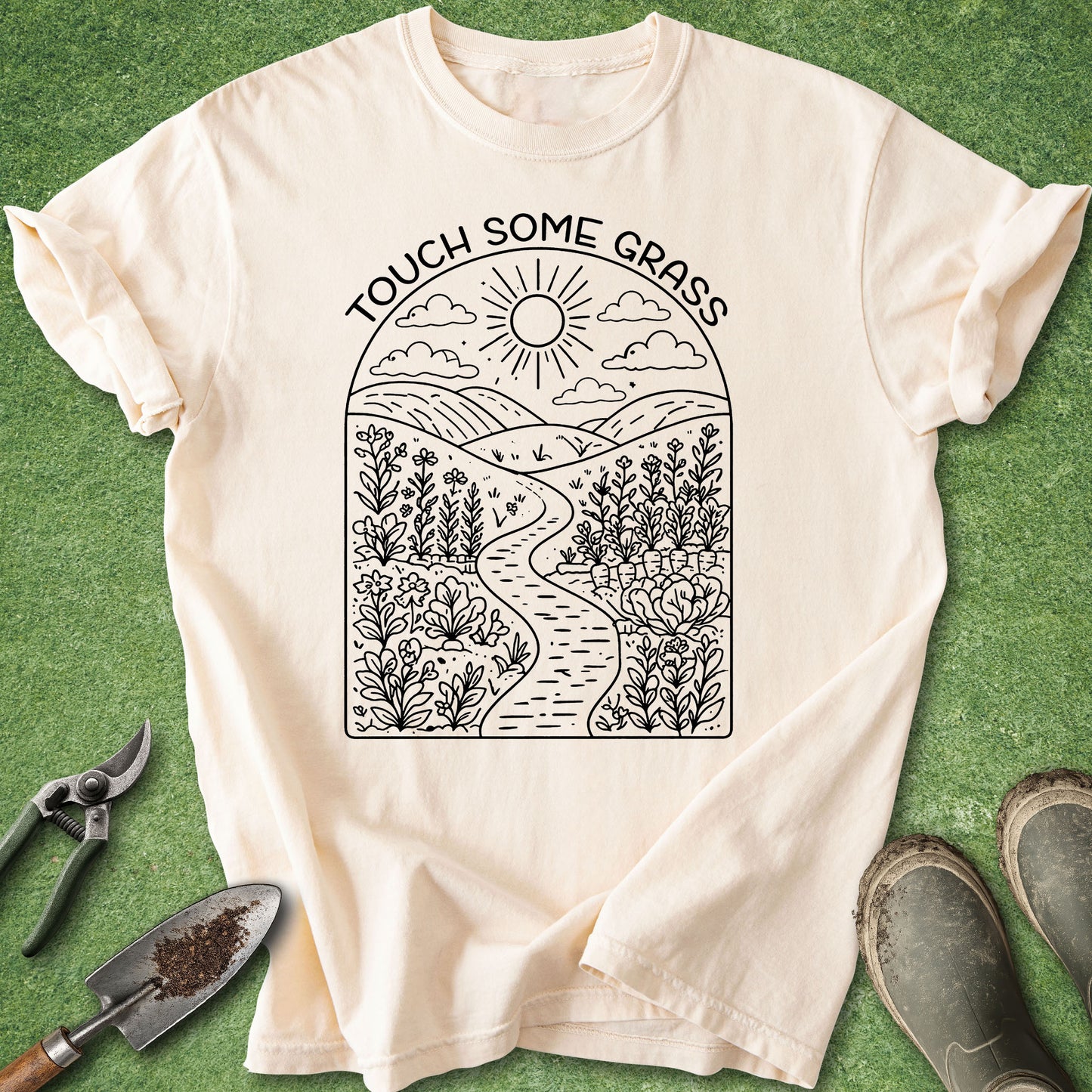 Beige t-shirt with nature-themed design and text 'Touch Some Grass' on a green background.
