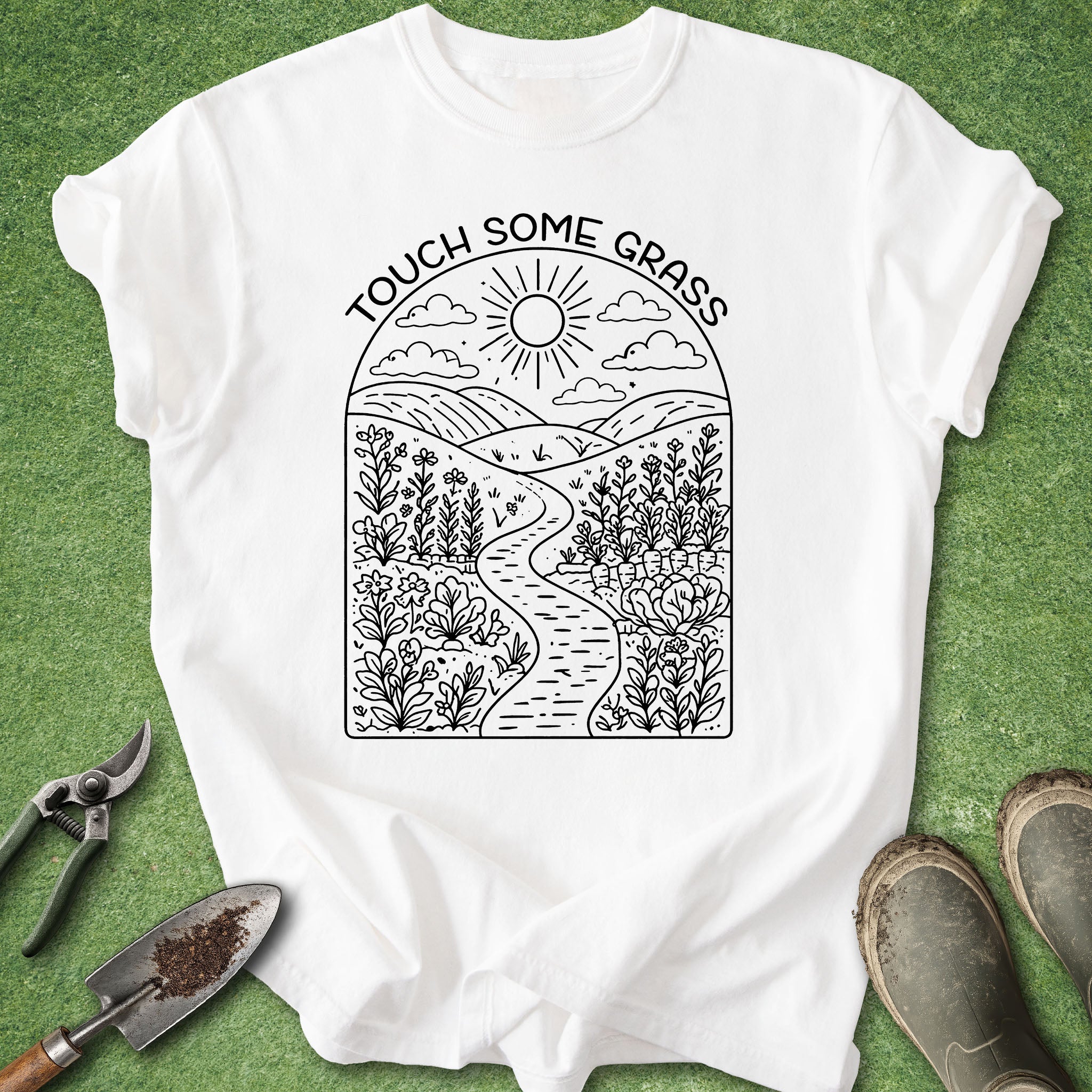 White t-shirt with nature-themed design and text 'Touch Some Grass' on a green background.