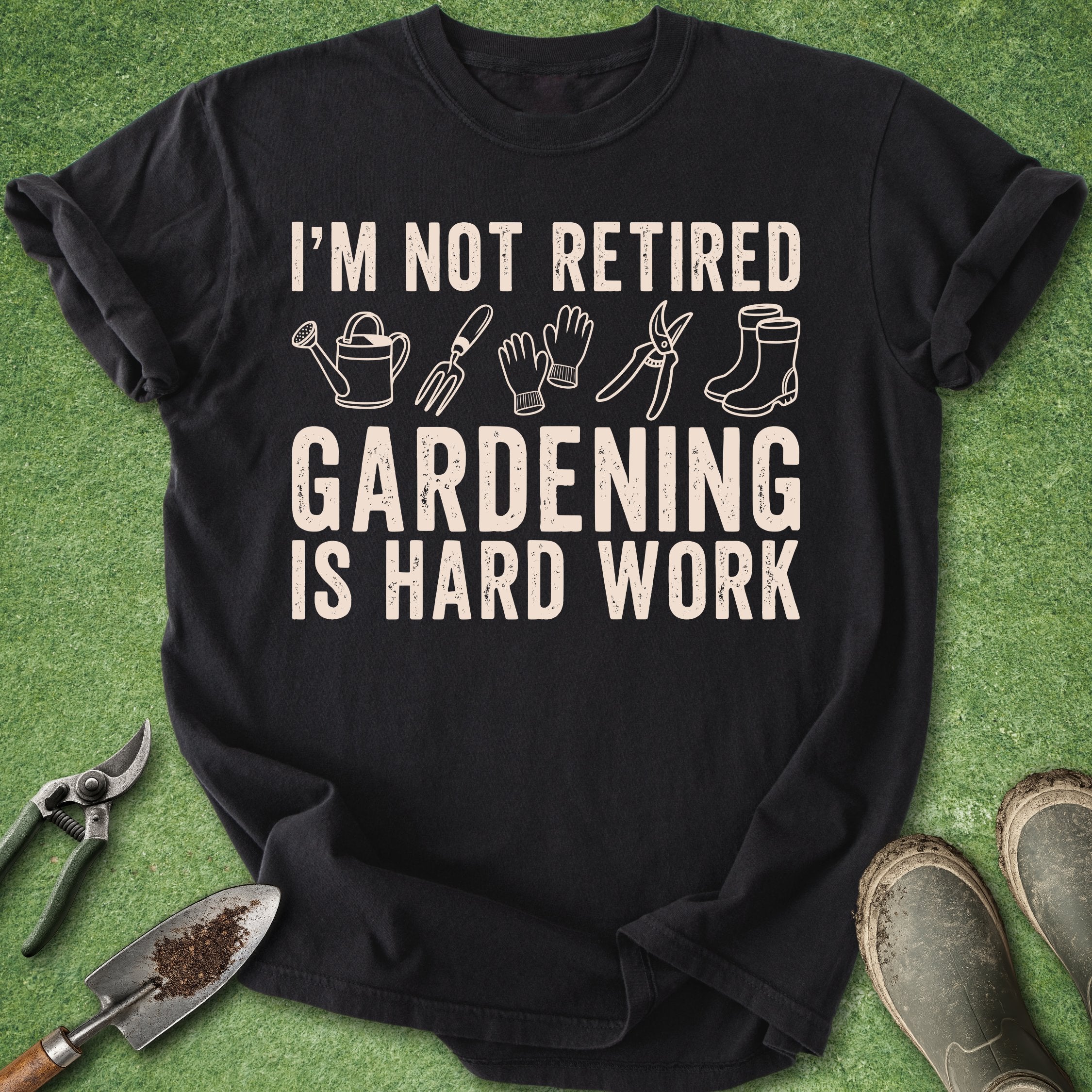 Black t-shirt with gardening-themed text and graphics on a green background with gardening tools.