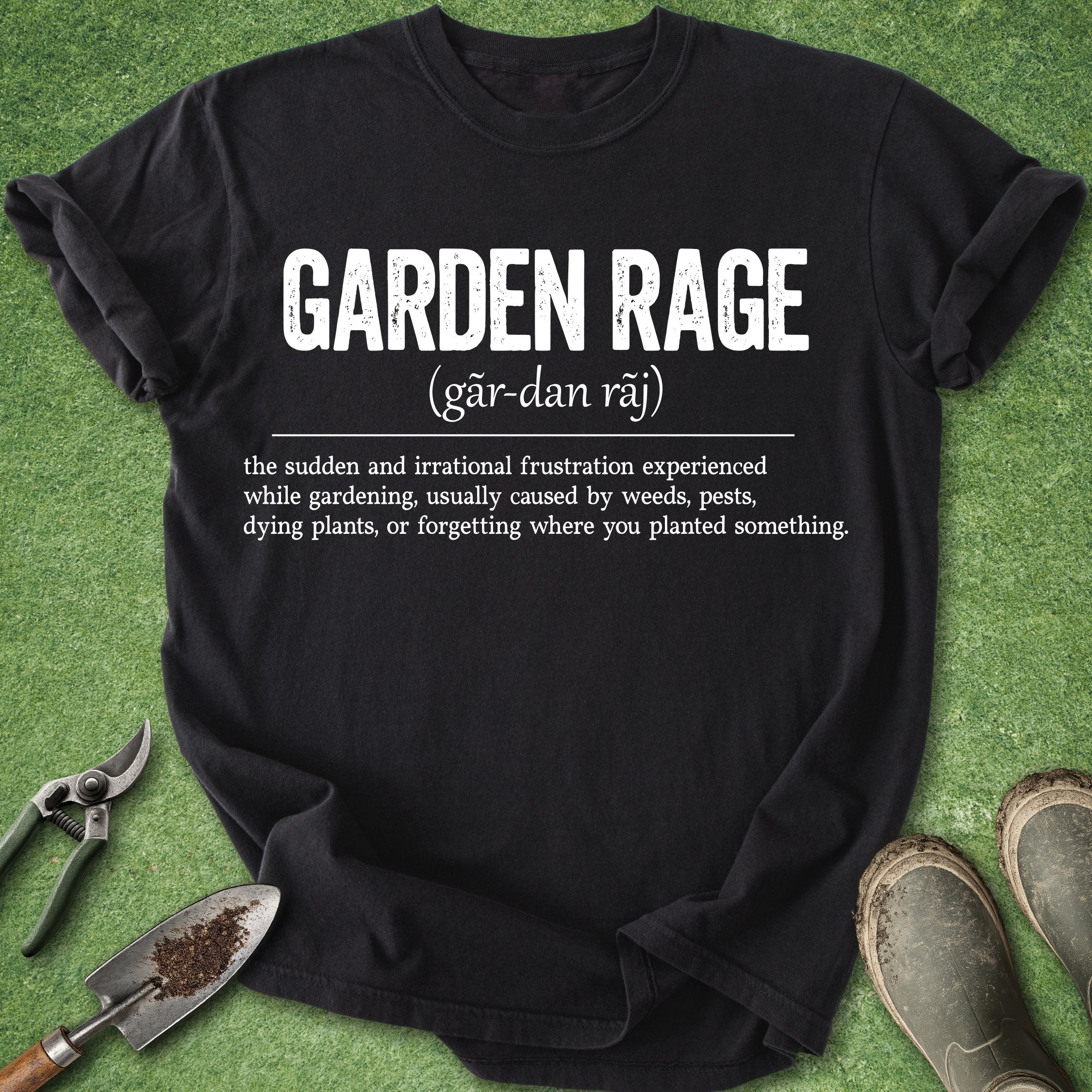 Black t-shirt with 'Garden Rage' definition on a grass background with gardening tools.