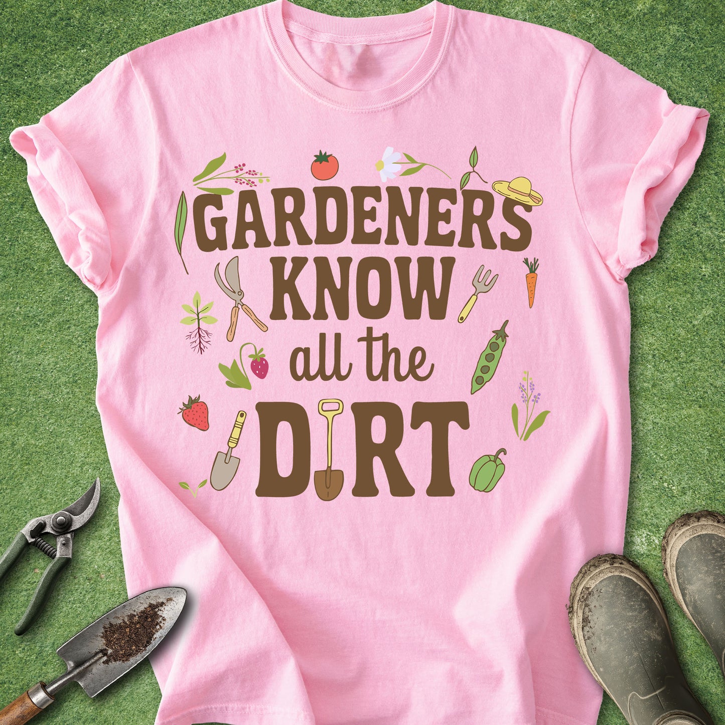 Pink t-shirt with gardening-themed text and graphics on a green background