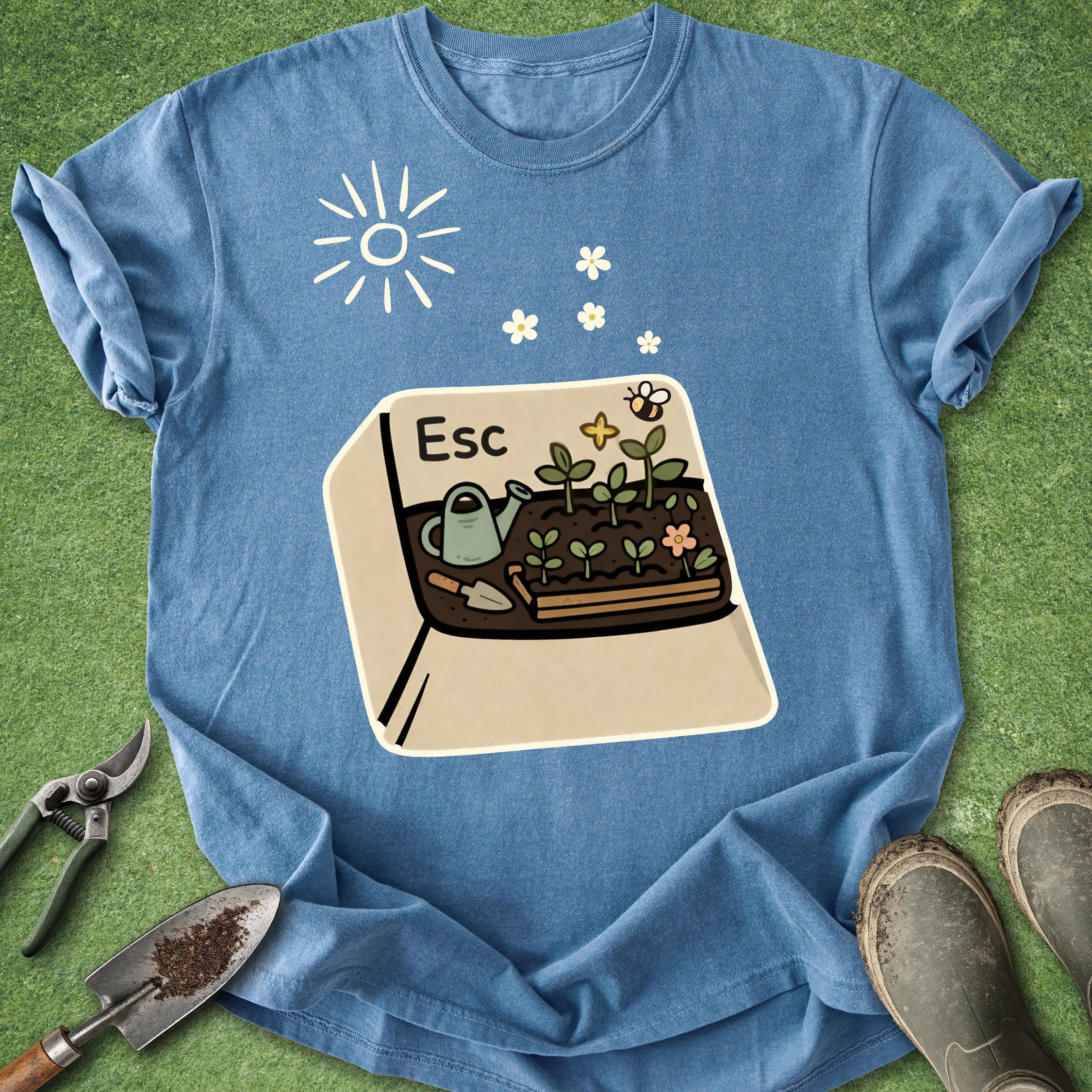 Blue t-shirt with a gardening graphic on a green grass background