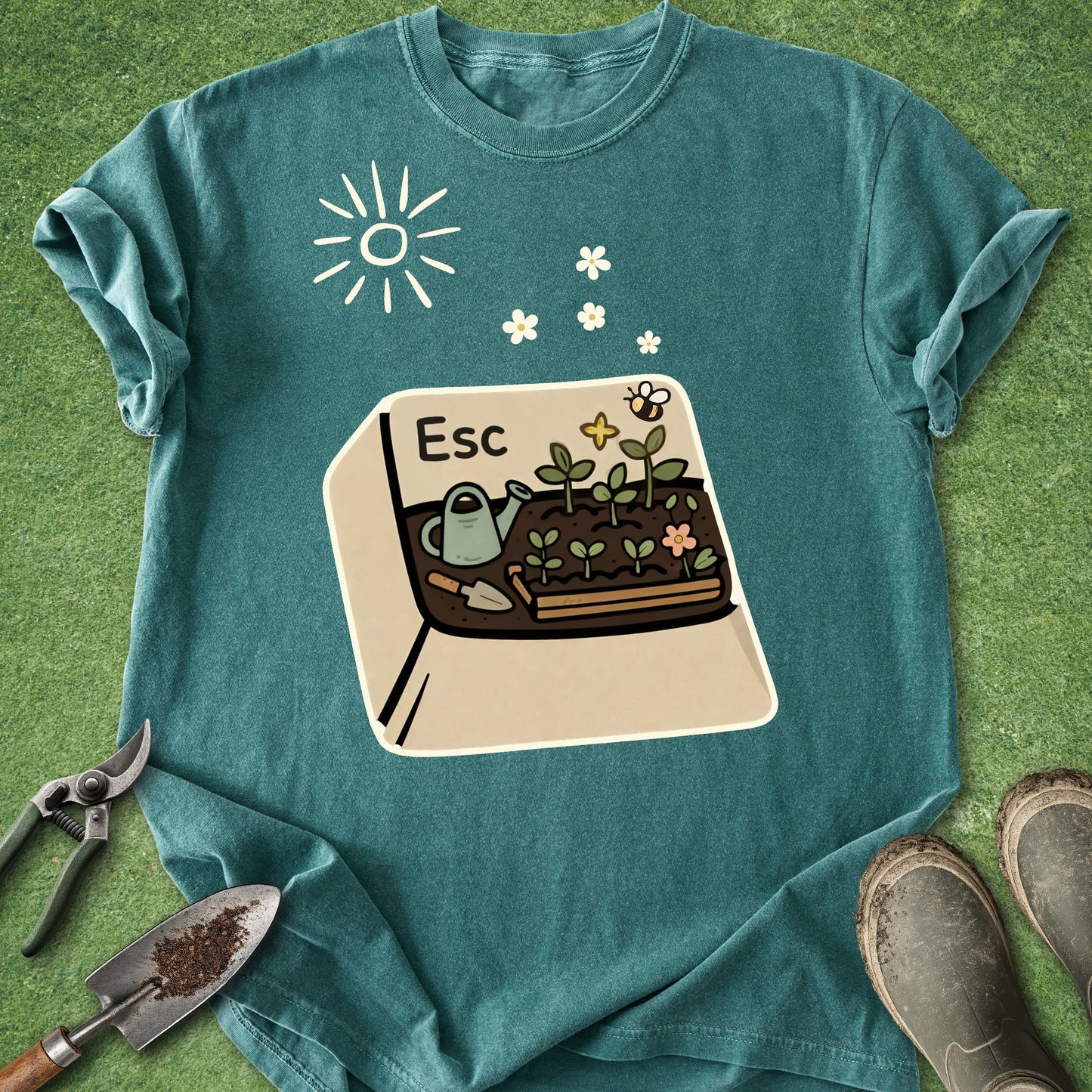 Teal t-shirt with a gardening graphic on a grassy background
