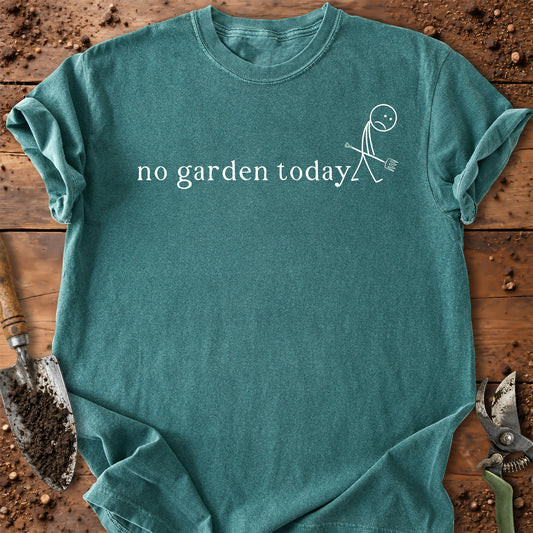 A teal short-sleeve t-shirt with the white printed text 'no garden today' and a simple stick figure gardening graphic, laid flat on a rustic wooden surface with gardening tools visible around the edges.