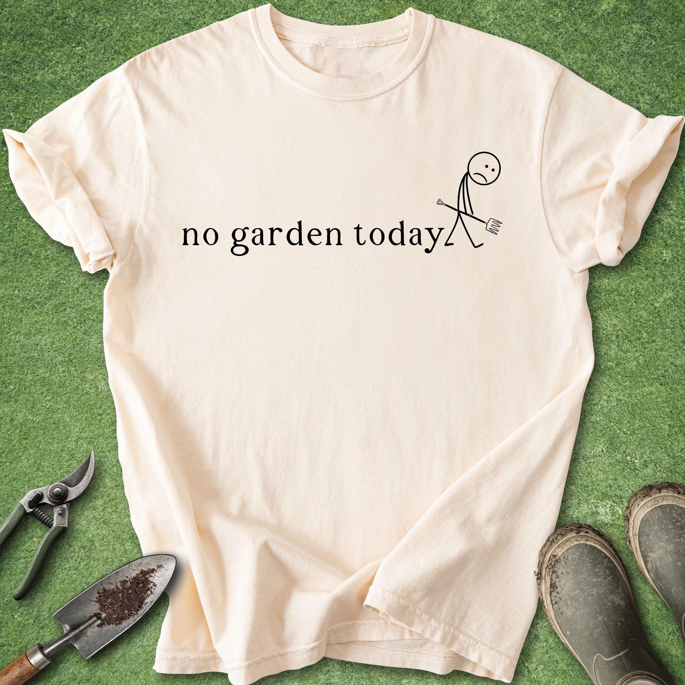 Beige t-shirt with 'no garden today' text and stick figure on a green grass background.