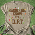Beige t-shirt with gardening-themed text and graphics on a green grass background