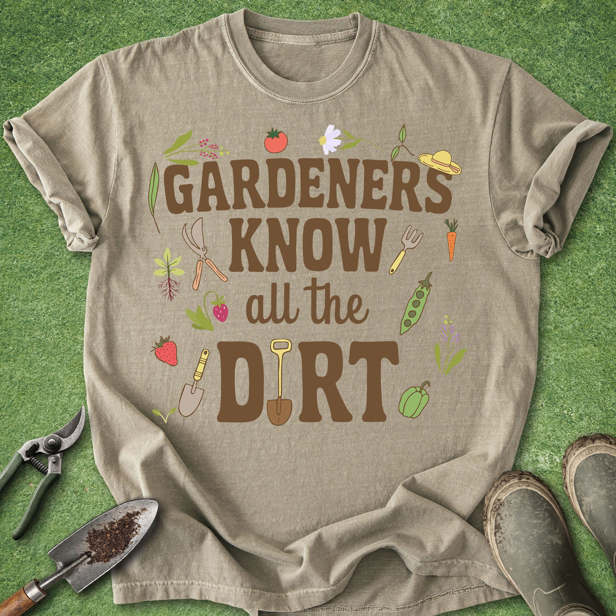 Beige t-shirt with gardening-themed text and graphics on a green grass background
