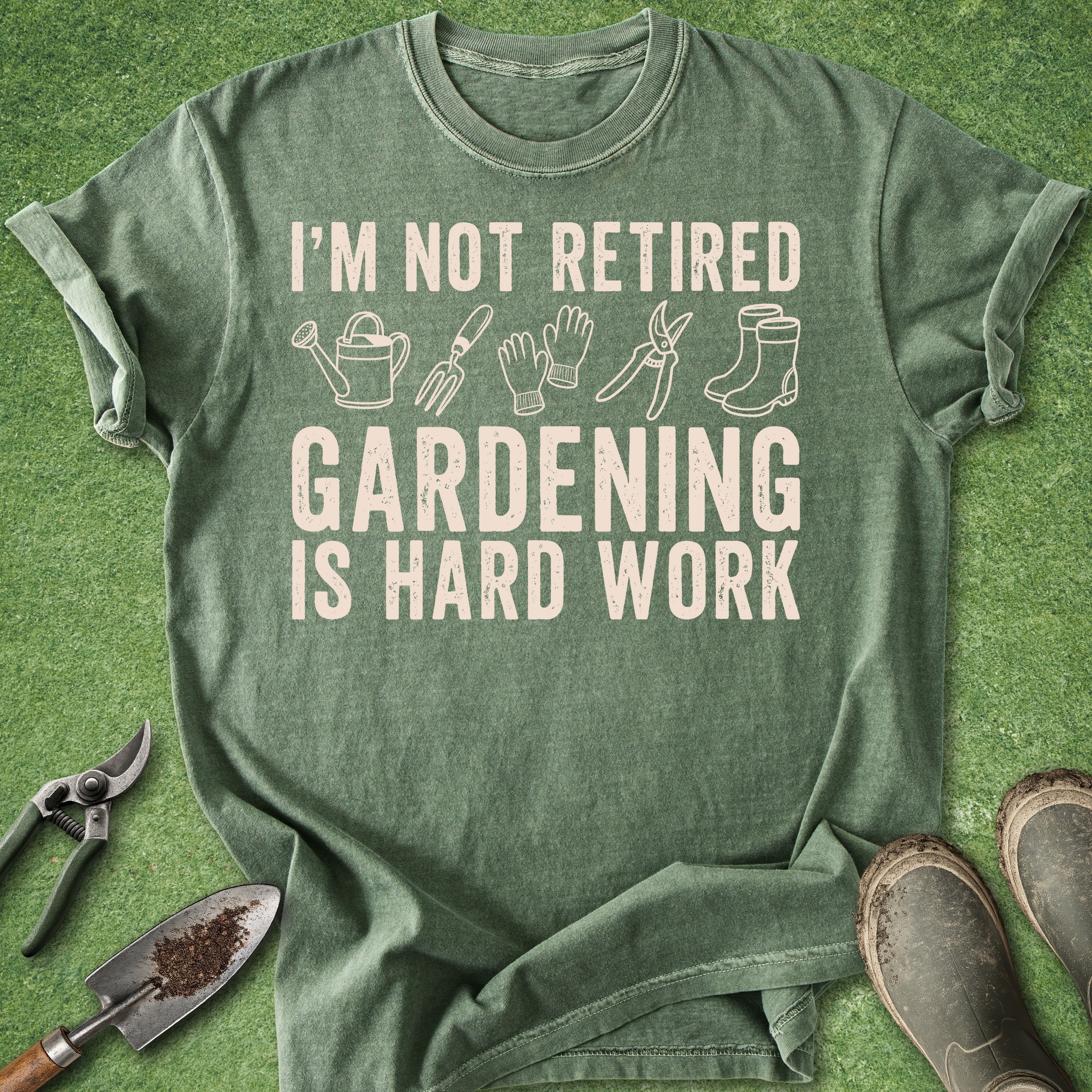 Green t-shirt with gardening-themed text and illustrations on a grass background