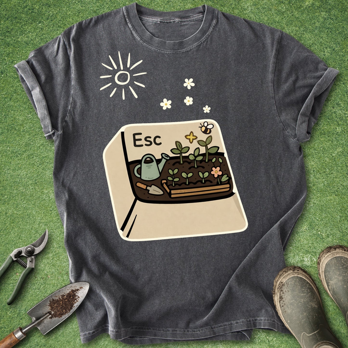 Dark gray t-shirt with a graphic of a computer screen showing plants, a frog, and flowers on a green grass background.