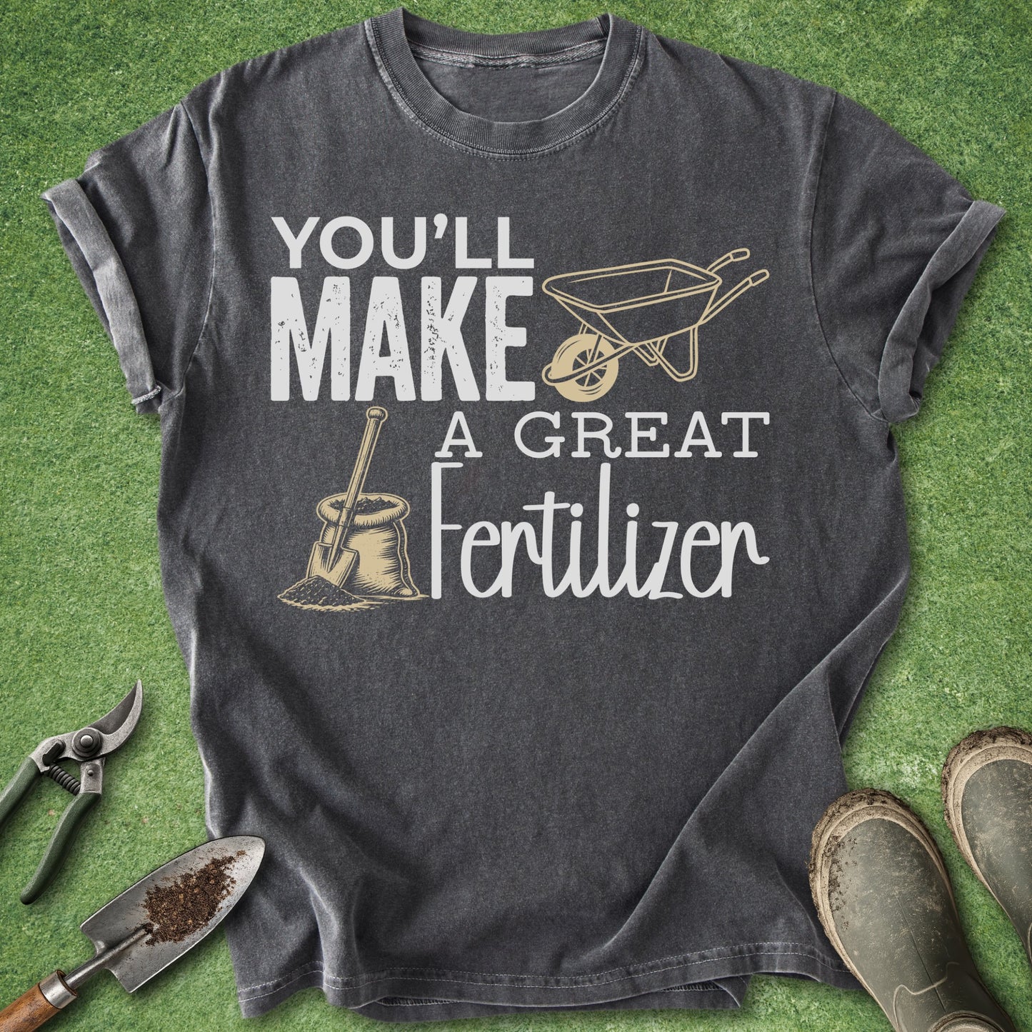 Gray t-shirt with gardening-themed text and graphics on a green grass background