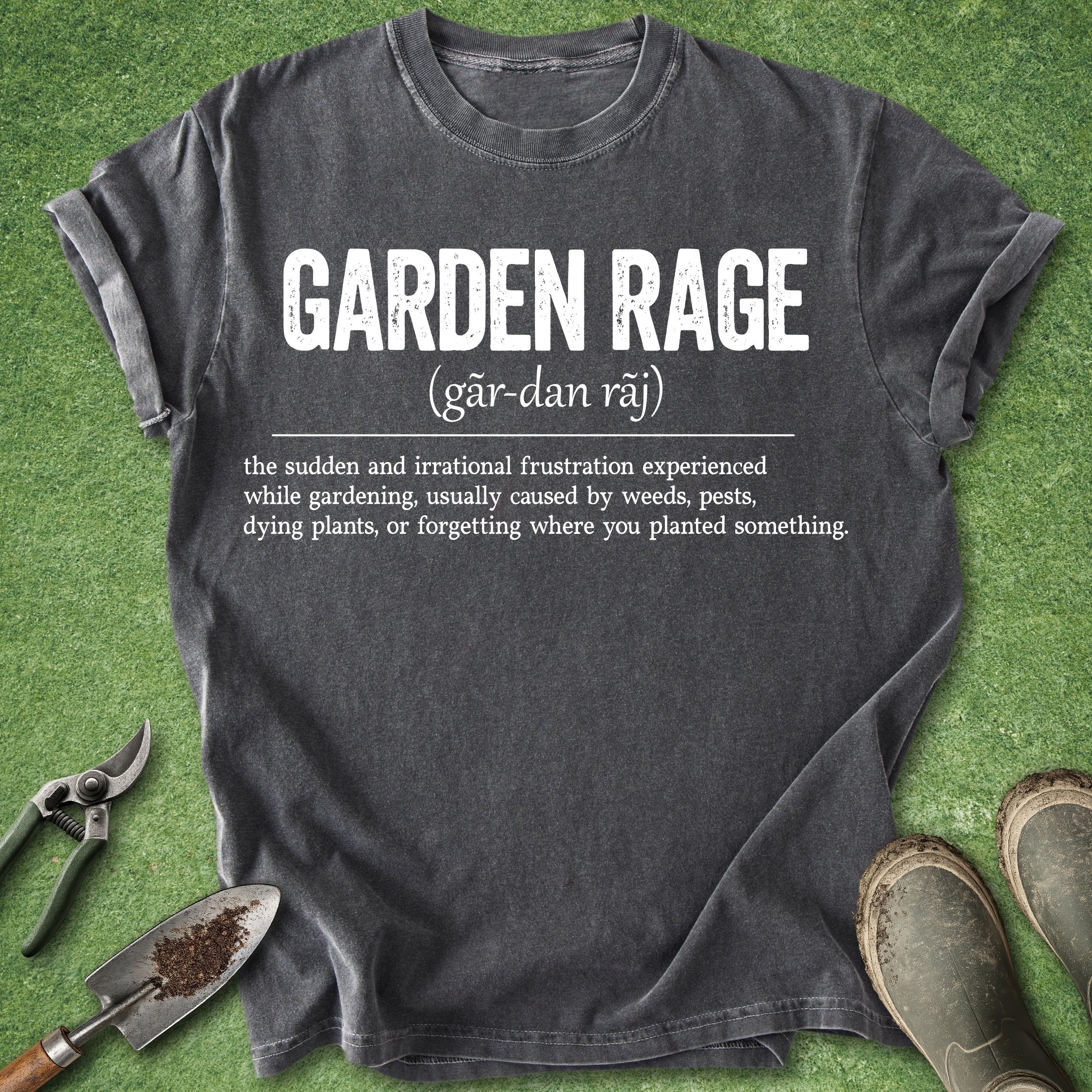 Black t-shirt with 'Garden Rage' definition on a grass background with gardening tools.