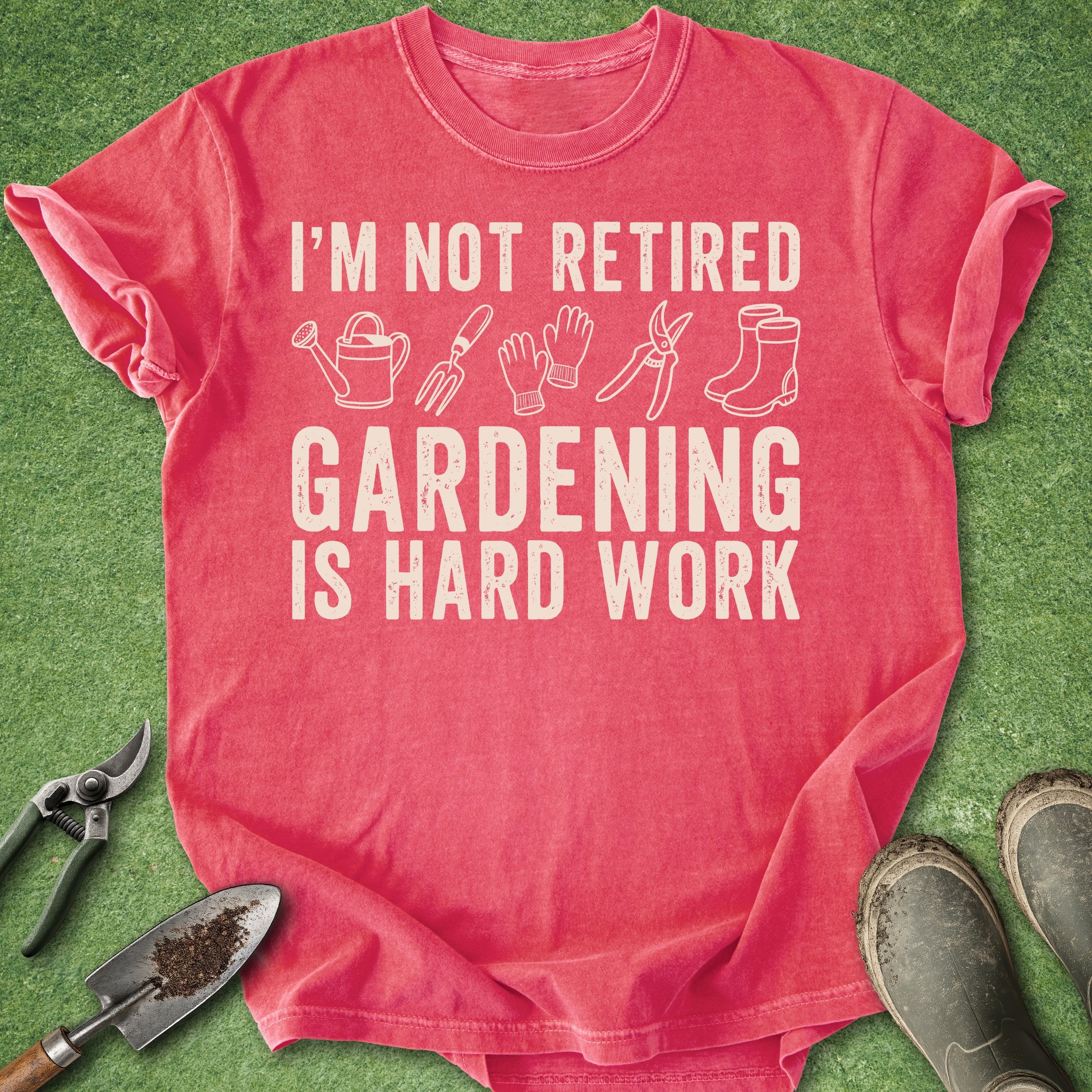 Red t-shirt with gardening-themed text and icons on a green background