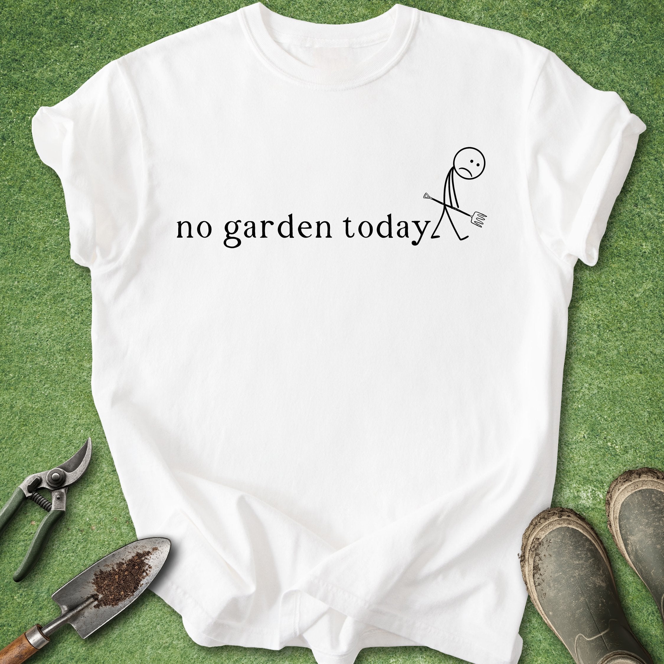 White t-shirt with 'no garden today' text and stick figure on grass with gardening tools.