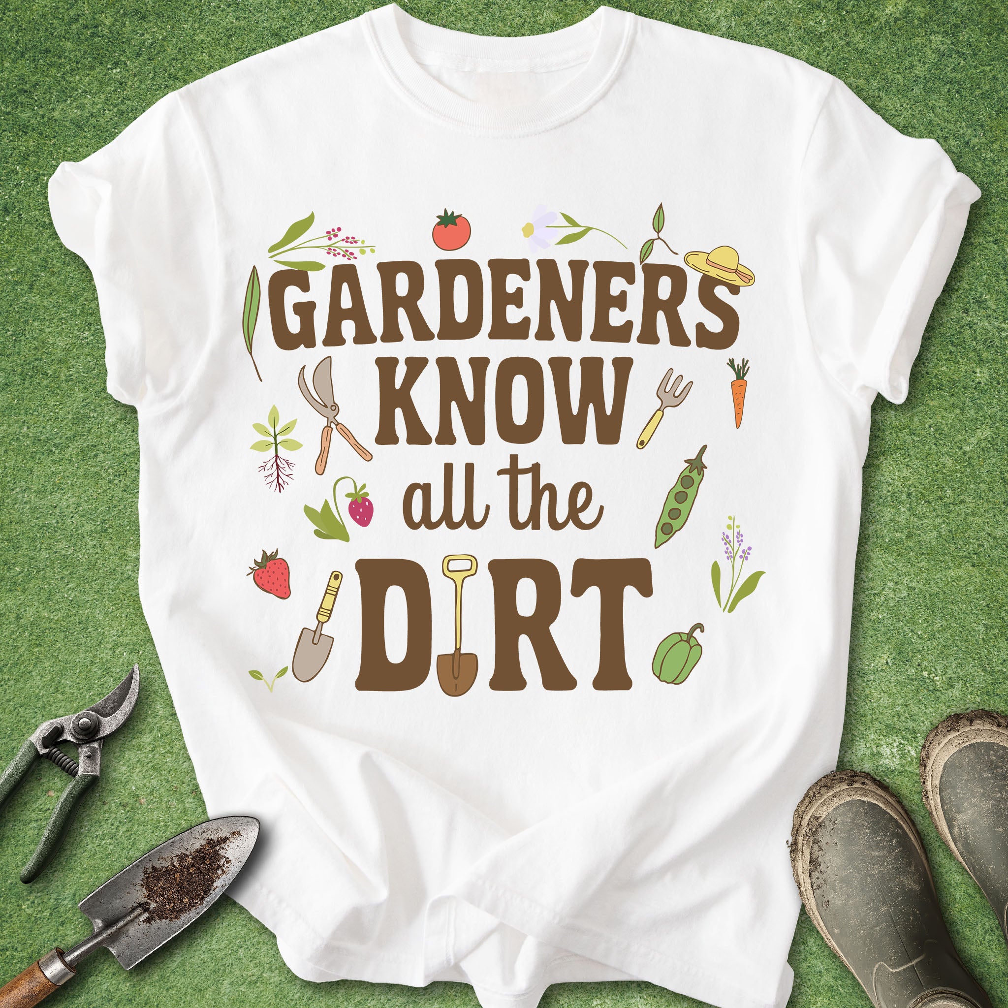 White t-shirt with gardening-themed text and graphics on a green background