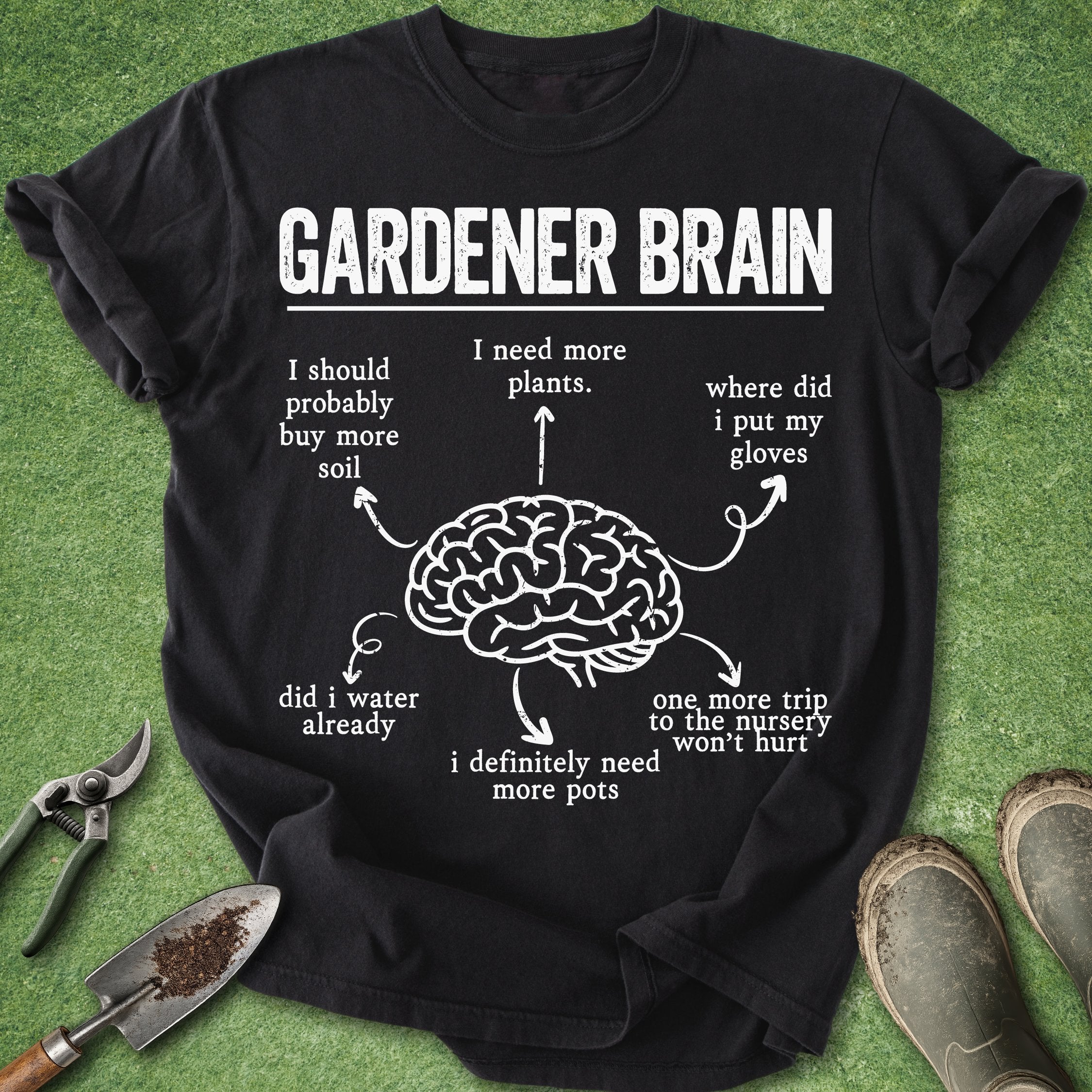 Black t-shirt with 'Gardener Brain' graphic and text on a grass background with gardening tools.