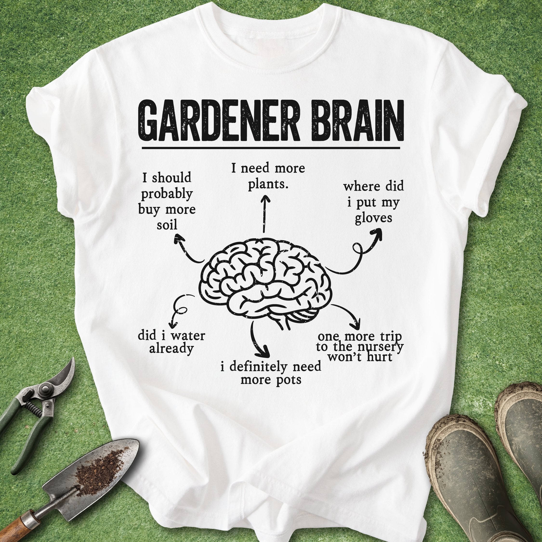 White t-shirt with 'Gardener Brain' graphic and text on a green background with gardening tools.
