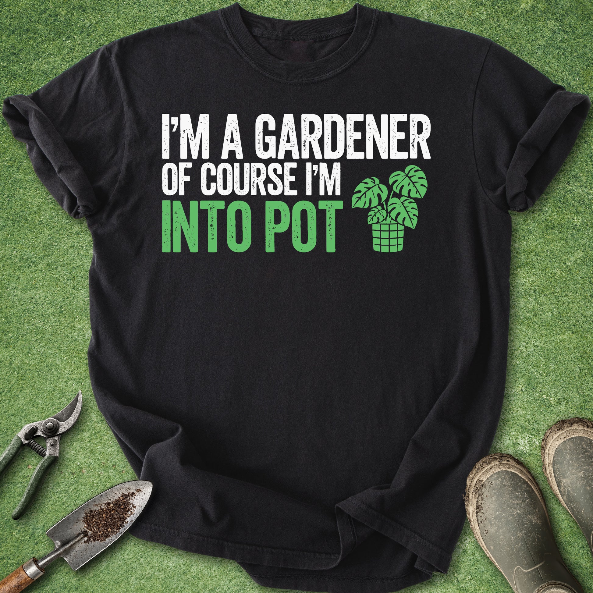 Black t-shirt with gardening-themed text and graphics on a green background with gardening tools.