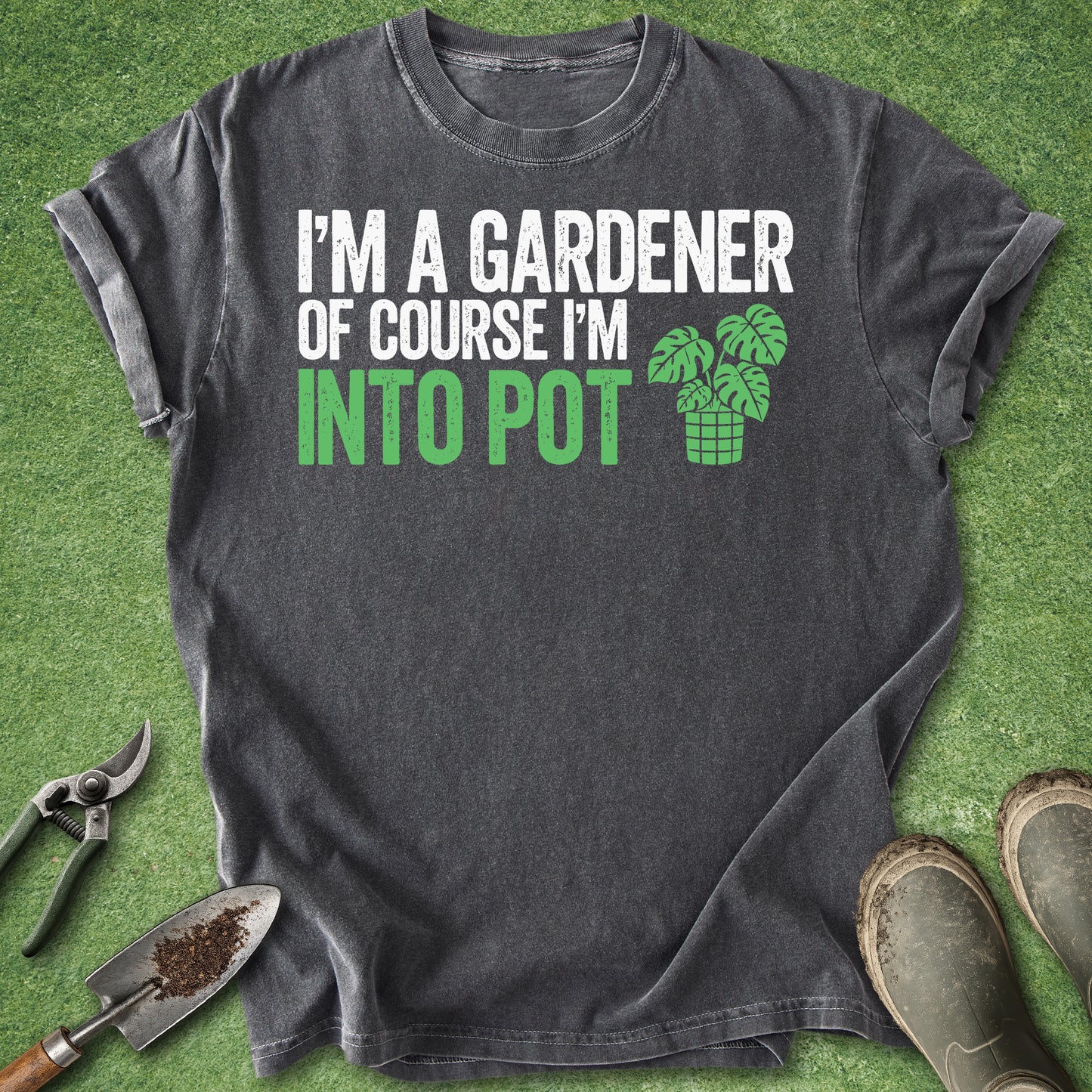 Gray t-shirt with gardening-themed text and graphics on a grass background