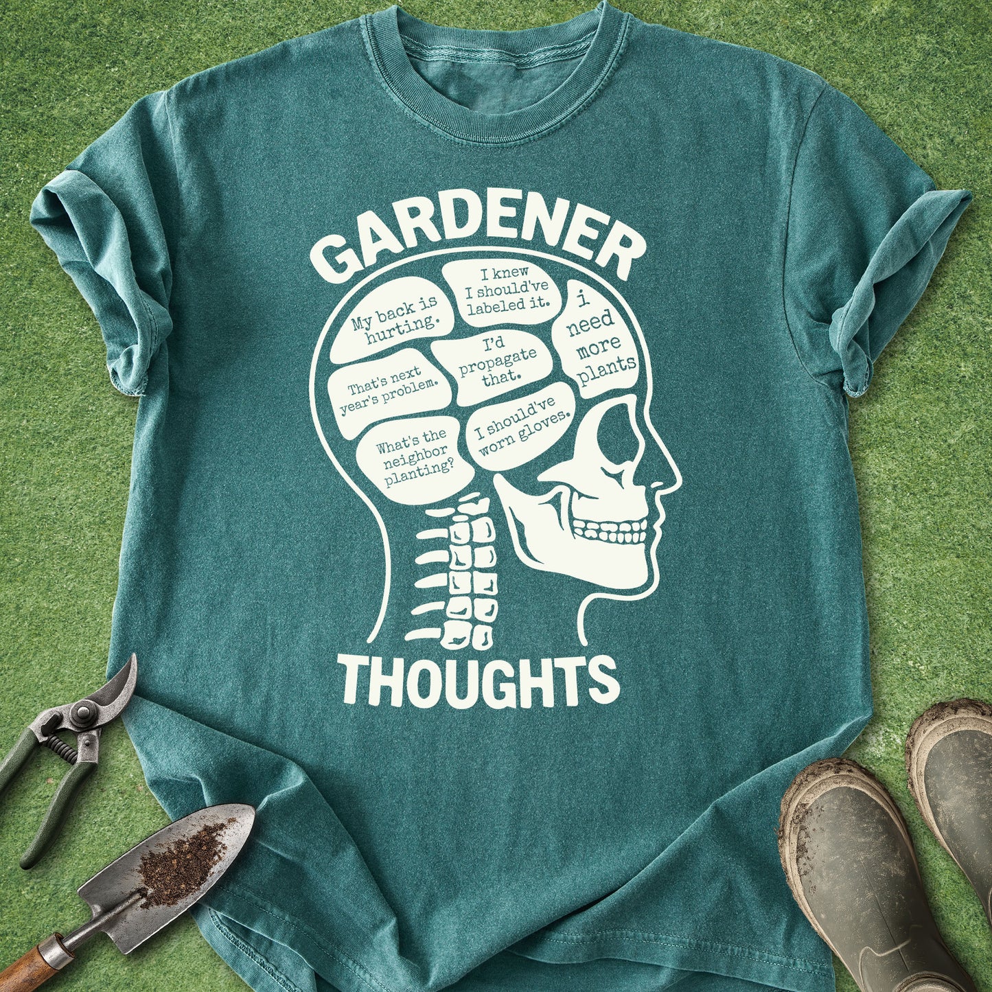 Blue Spruce Comfort Colors t-shirt featuring a humorous "Gardener Thoughts" anatomy graphic filled with funny gardening phrases like "My back is hurting," "I'd propagate that," and "I need more plants."