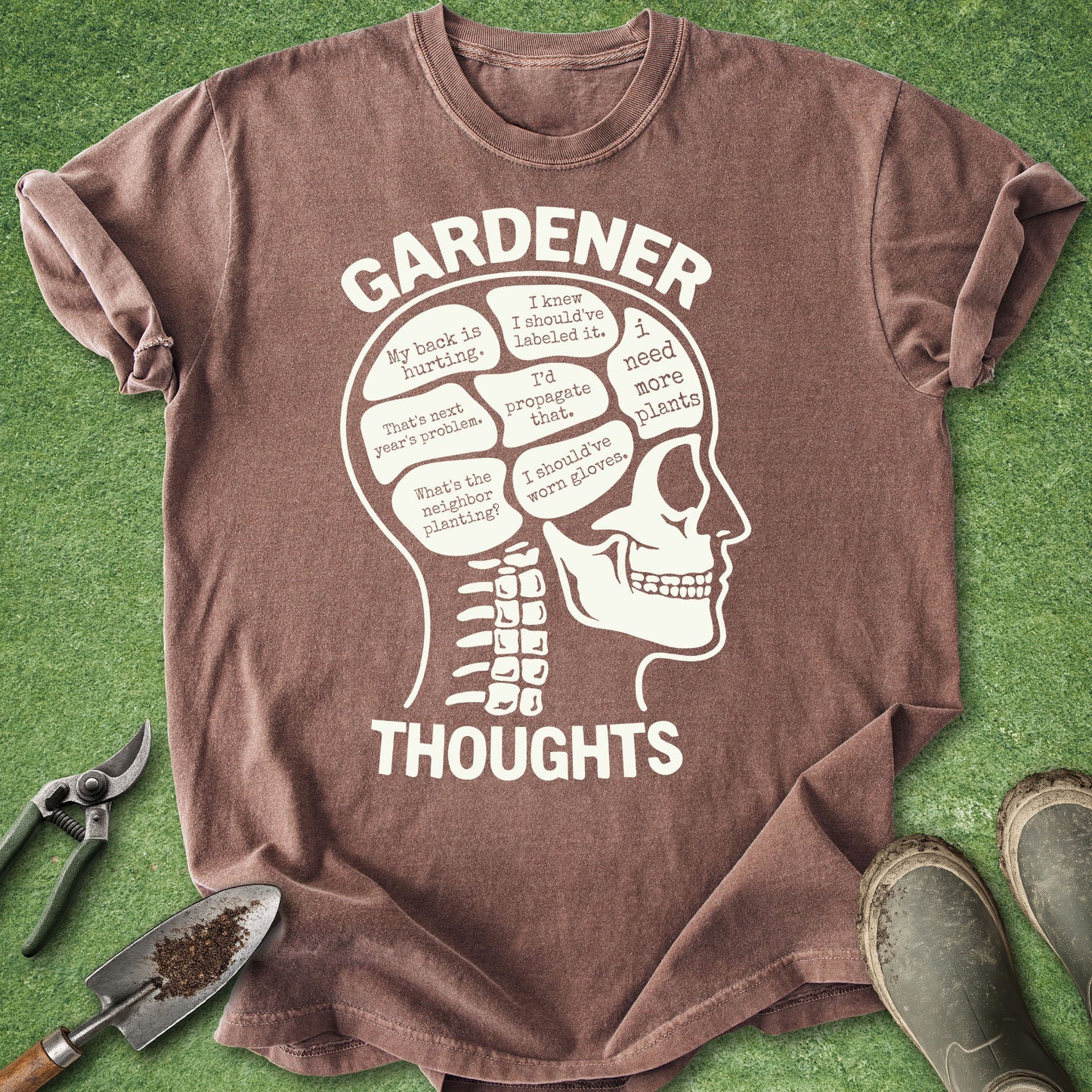 Brown t-shirt with white graphic and text on a green background
