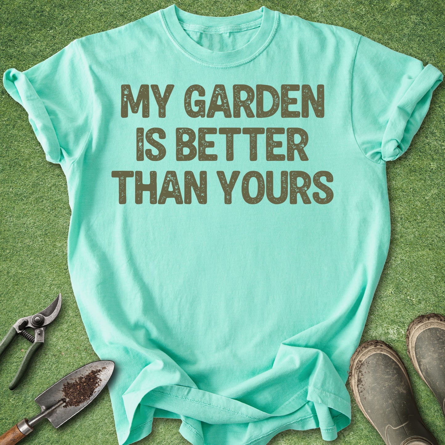 Mint green t-shirt with 'My garden is better than yours' text on a grass background.
