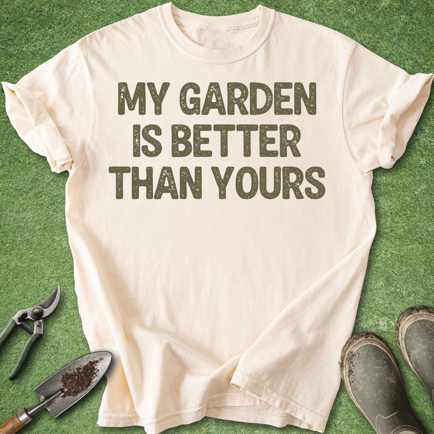 Funny gardening t-shirt reading “My Garden Is Better Than Yours” in distressed green typography on ivory shirt
