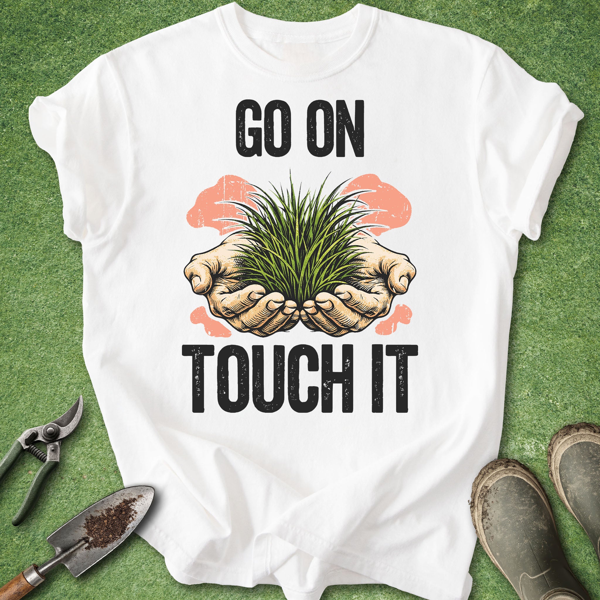 White t-shirt with 'Go on, touch it' graphic and plants on a green background