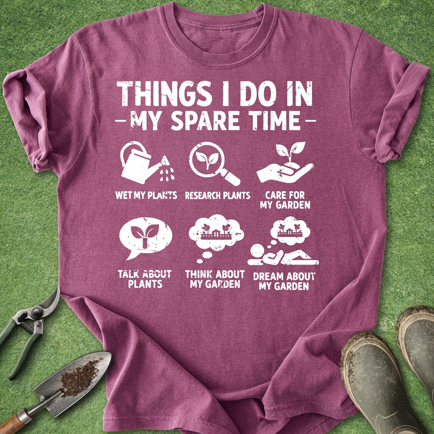 Purple t-shirt with gardening-themed text and icons on a grass background