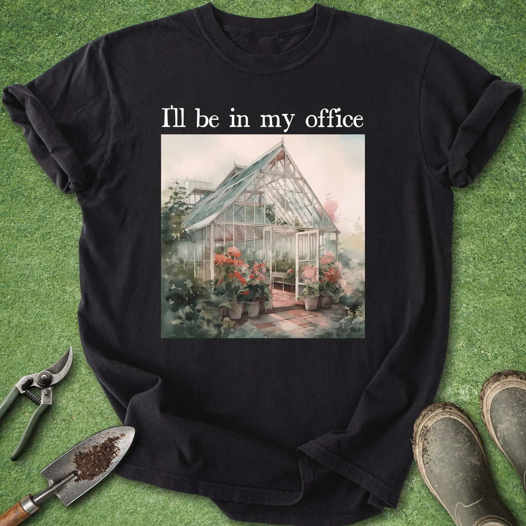 Black t-shirt with a greenhouse illustration and text 'I'll be in my office' on a grass background.