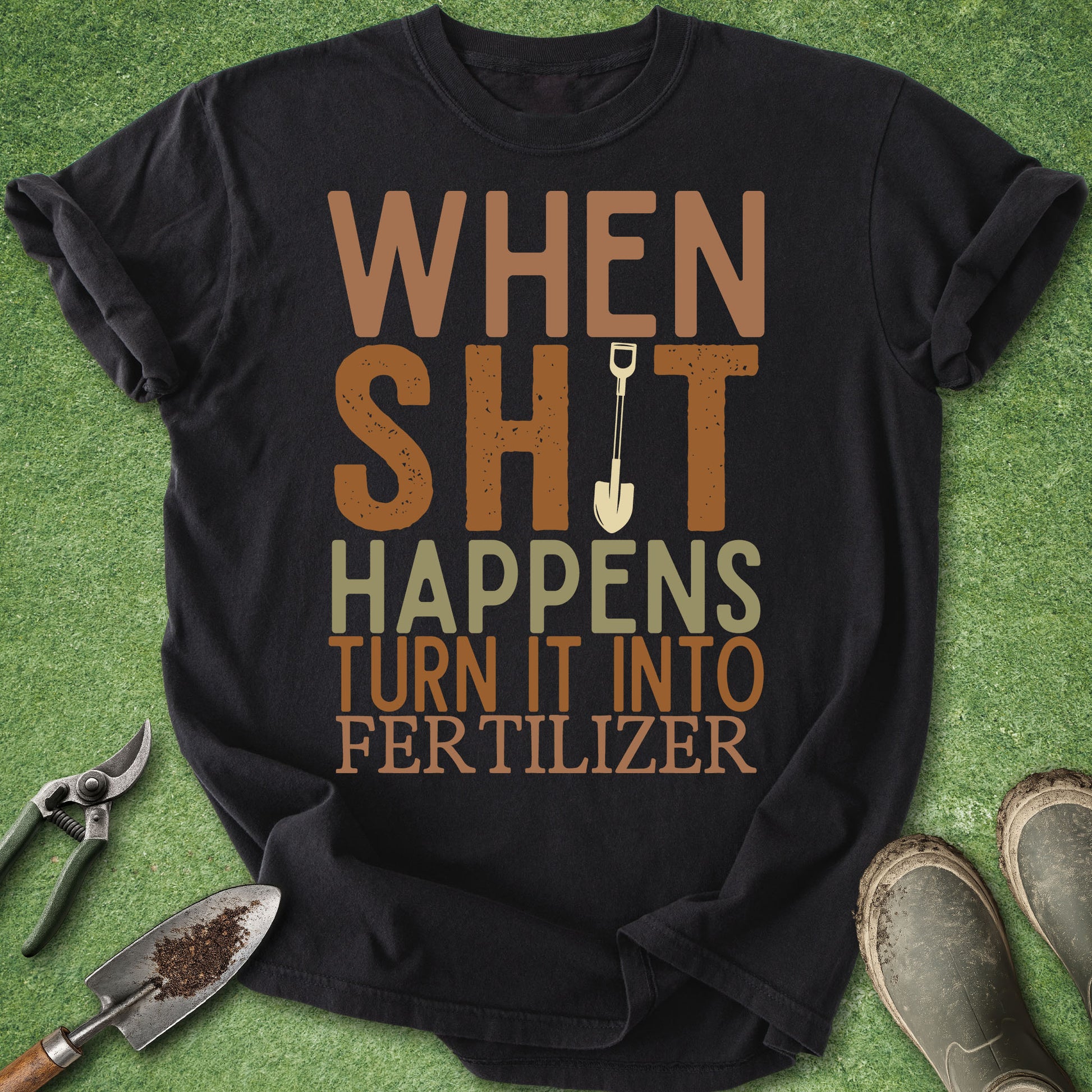 Black t-shirt with humorous text on a green background with gardening tools.