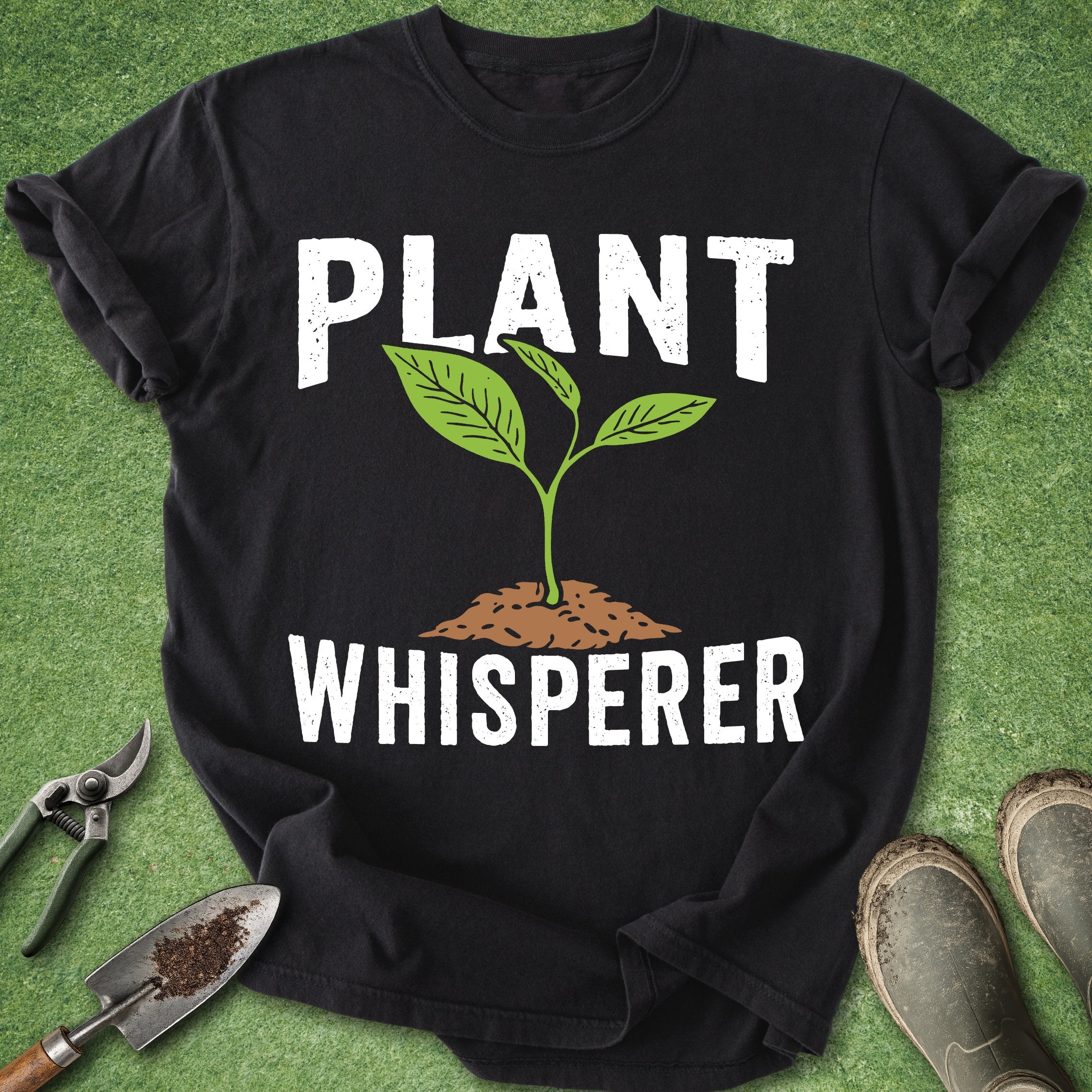 Black t-shirt with 'Plant Whisperer' design on a green grass background