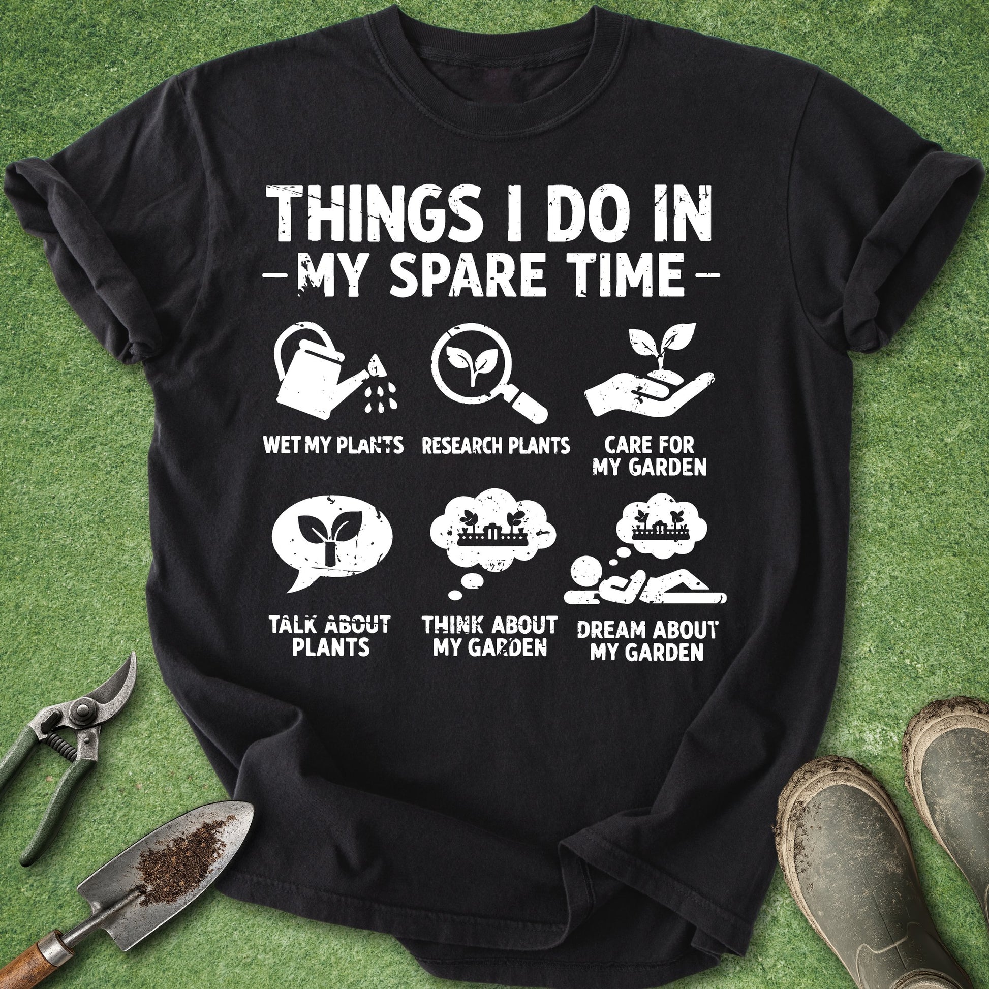 Black t-shirt with gardening-themed text and icons on a grass background