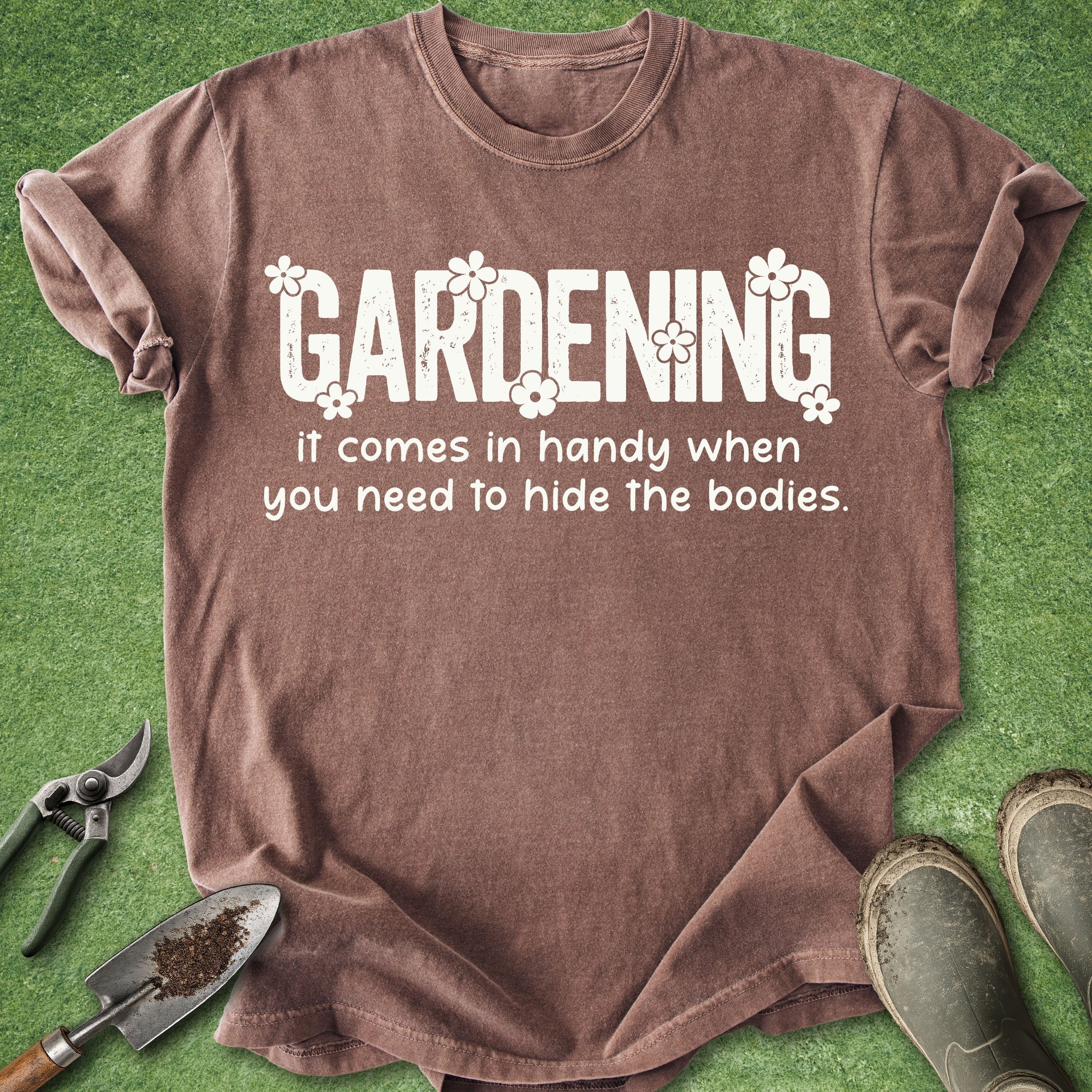 Brown t-shirt with humorous gardening text on a green background