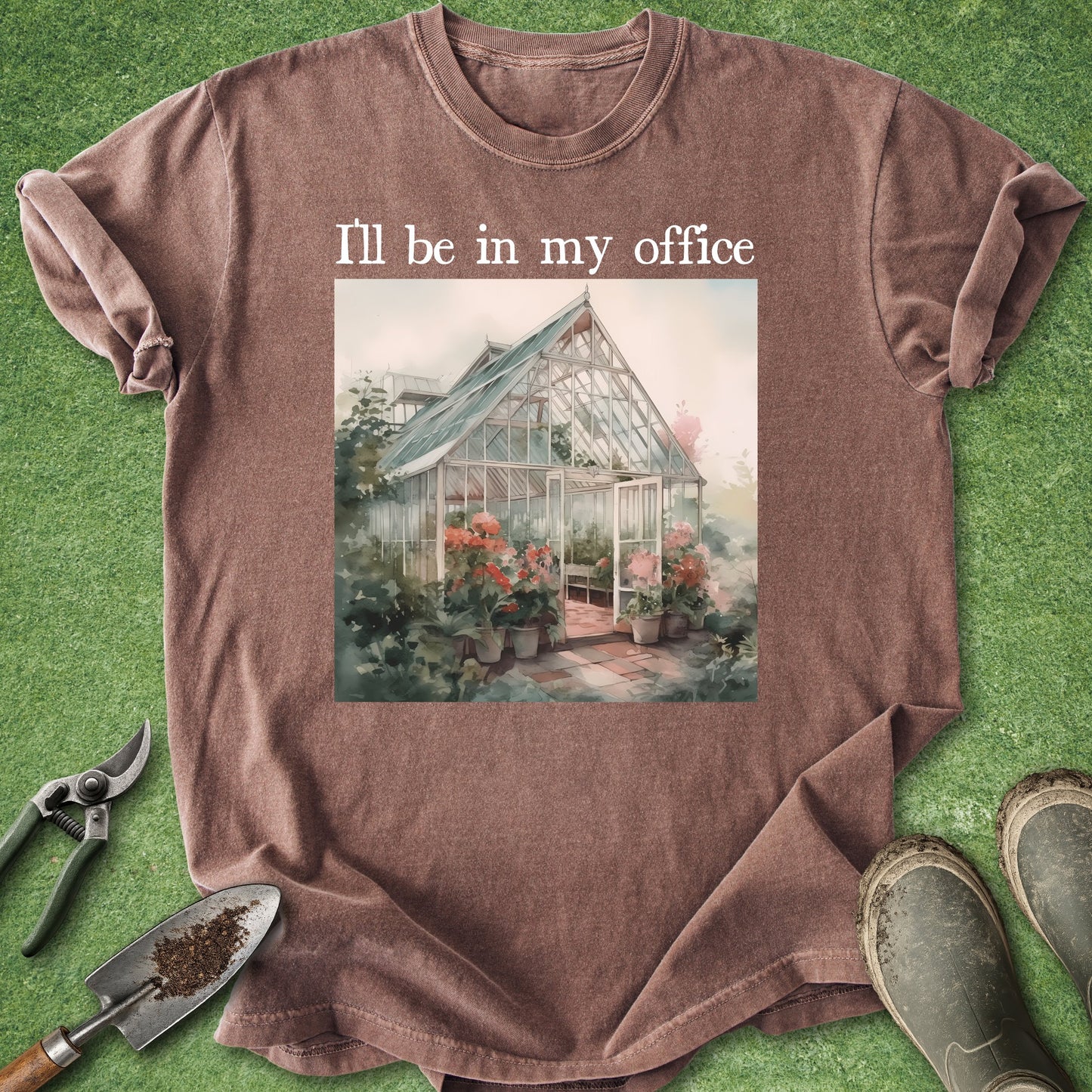 Brown t-shirt with greenhouse graphic and text 'I'll be in my office' on a grass background.