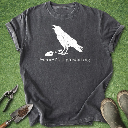 Funny gardening shirt featuring a distressed white crow silhouette standing beside a garden trowel with the phrase "F-Caw-F I'm Gardening" on a dark charcoal background.