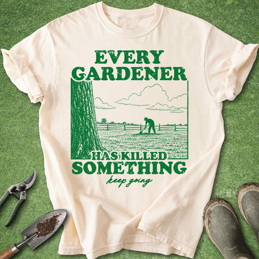 Comfort Colors Ivory t-shirt featuring the quote "Every Gardener Has Killed Something, Keep Going" with a vintage-style illustration of a gardener working in a field.