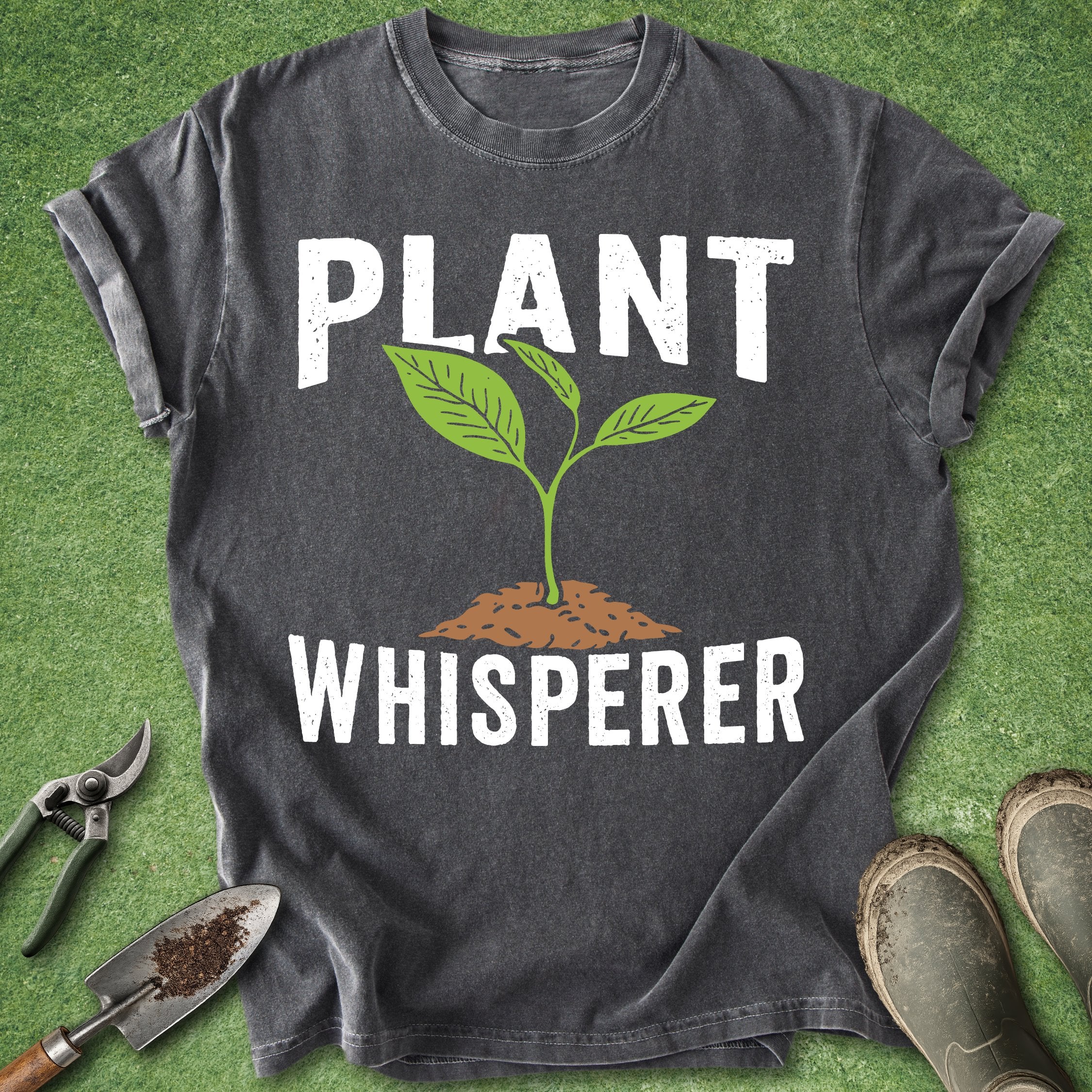 Dark gray t-shirt with 'Plant Whisperer' design on a grass background