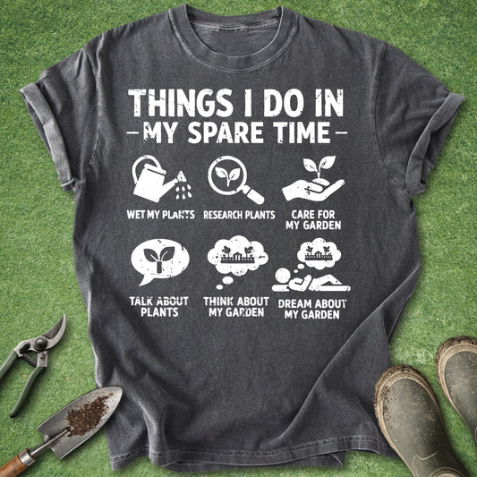 Gray t-shirt with gardening-themed text and icons on a green grass background