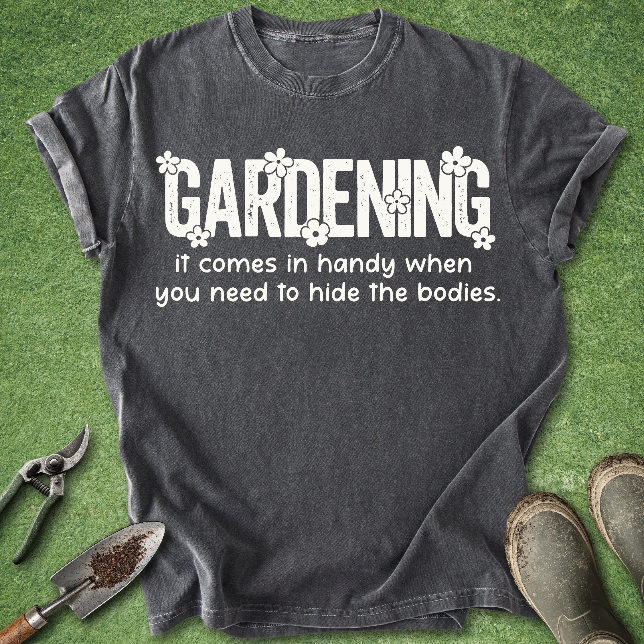 Gray t-shirt with humorous gardening quote on a green grass background