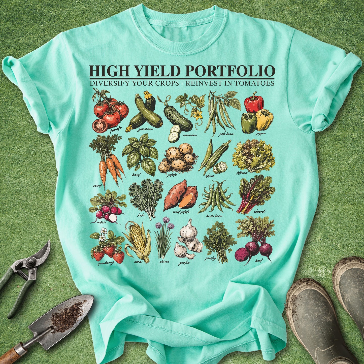 Teal t-shirt with vegetable illustrations and text on a green background