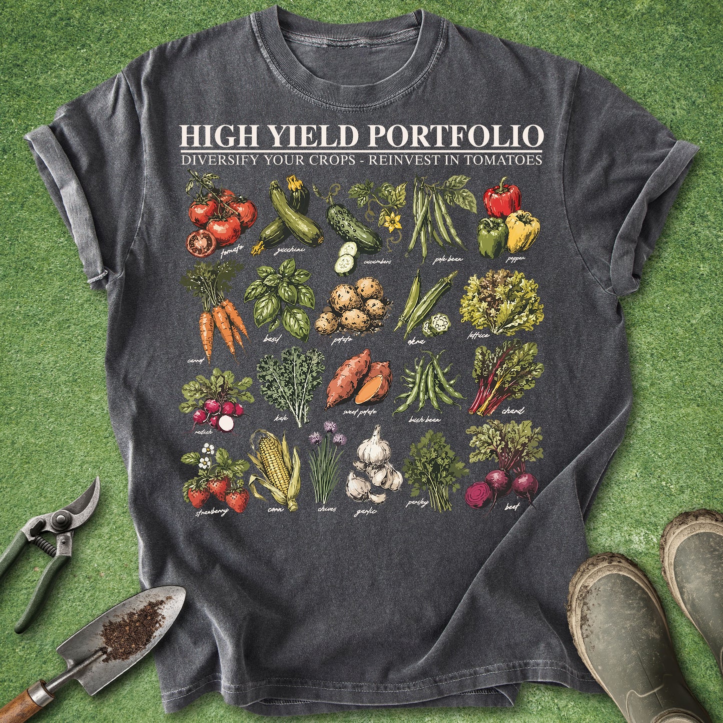 Gray t-shirt with vegetable illustrations and text on a green grass background