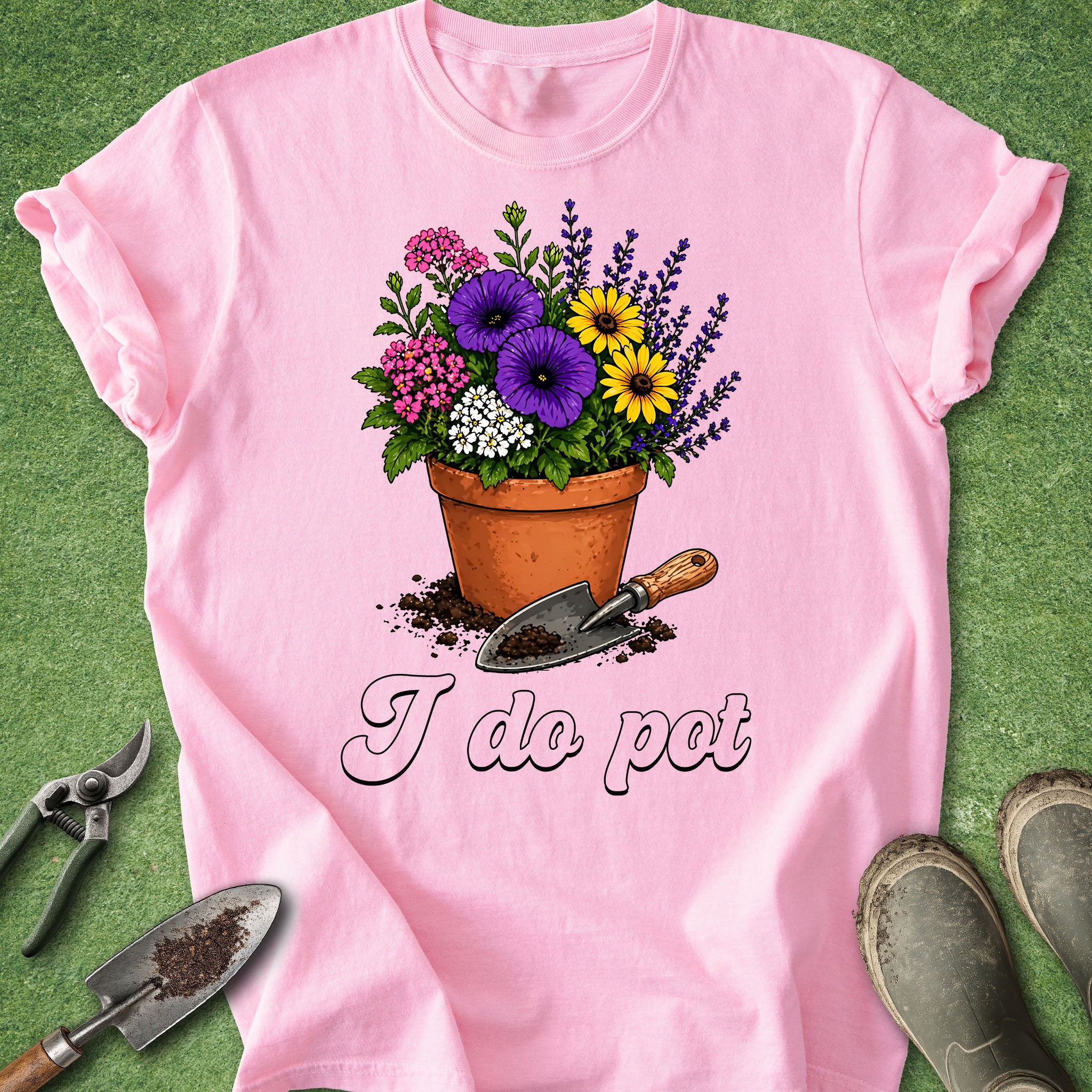 Pink t-shirt with a flower pot and gardening tools graphic on a green background