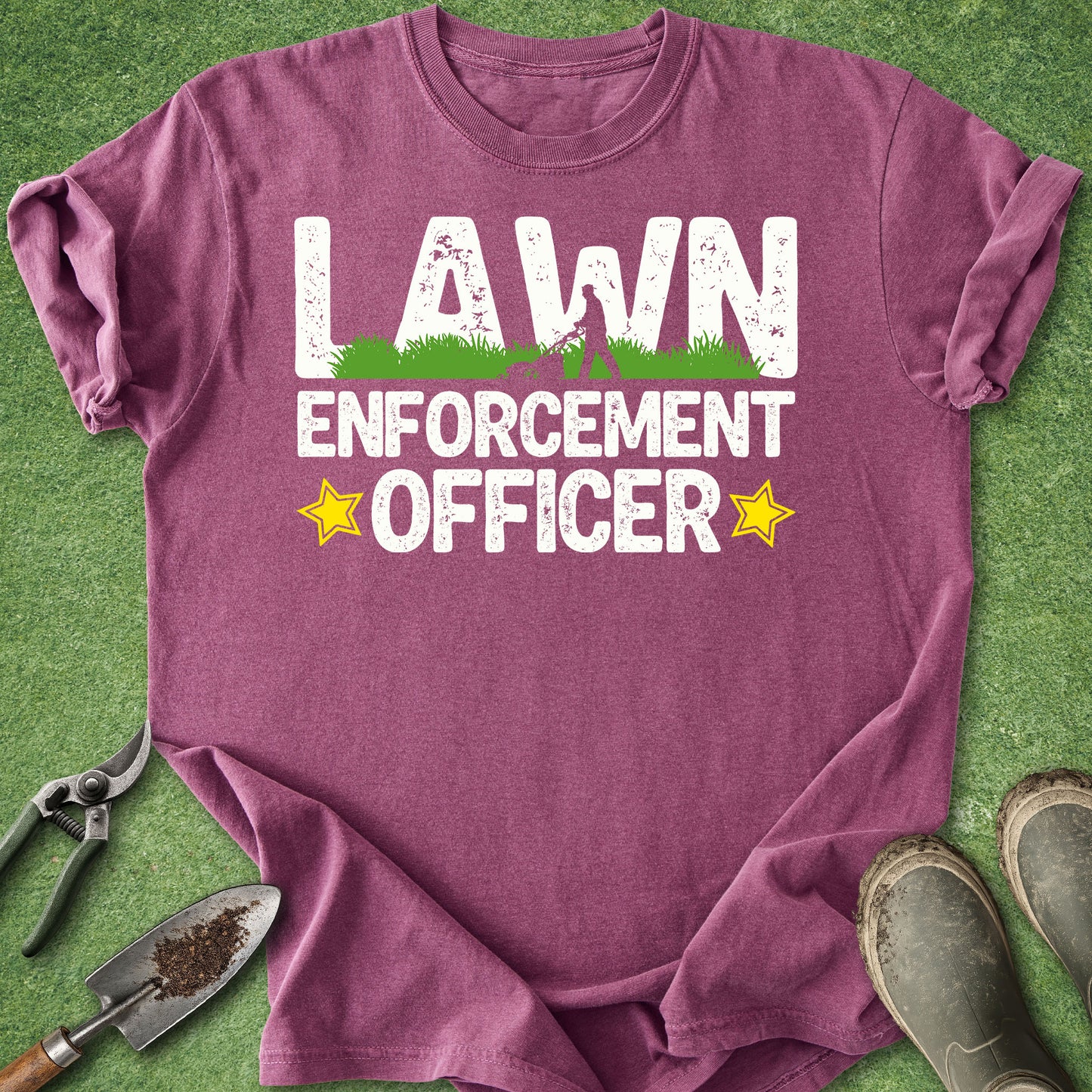 Purple t-shirt with 'Lawn Enforcement Officer' text on a grass background