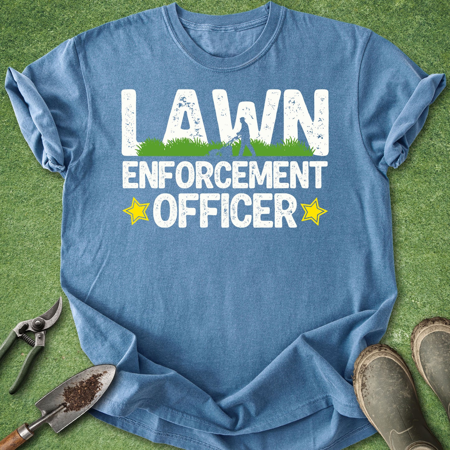 Blue t-shirt with 'Lawn Enforcement Officer' text on a grass background