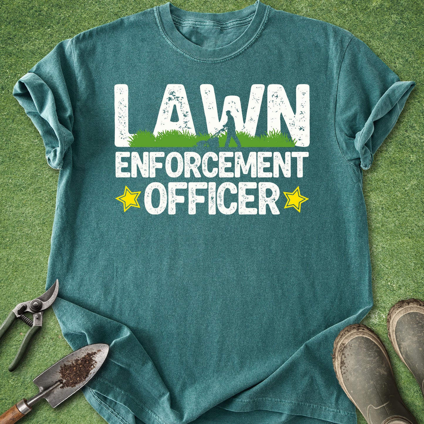 Teal t-shirt with 'Lawn Enforcement Officer' text on a grass background