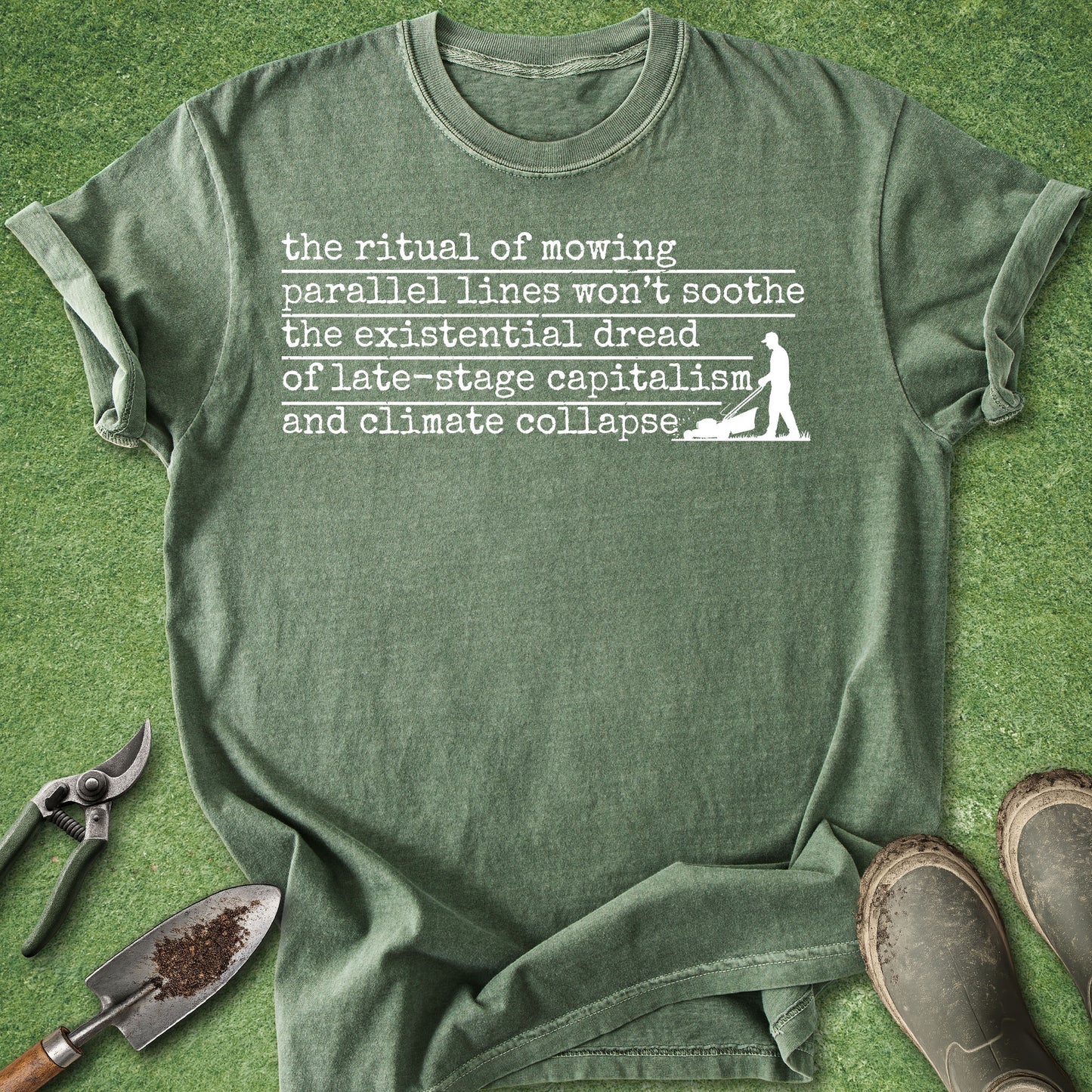 Green t-shirt with text and graphic on a grass background