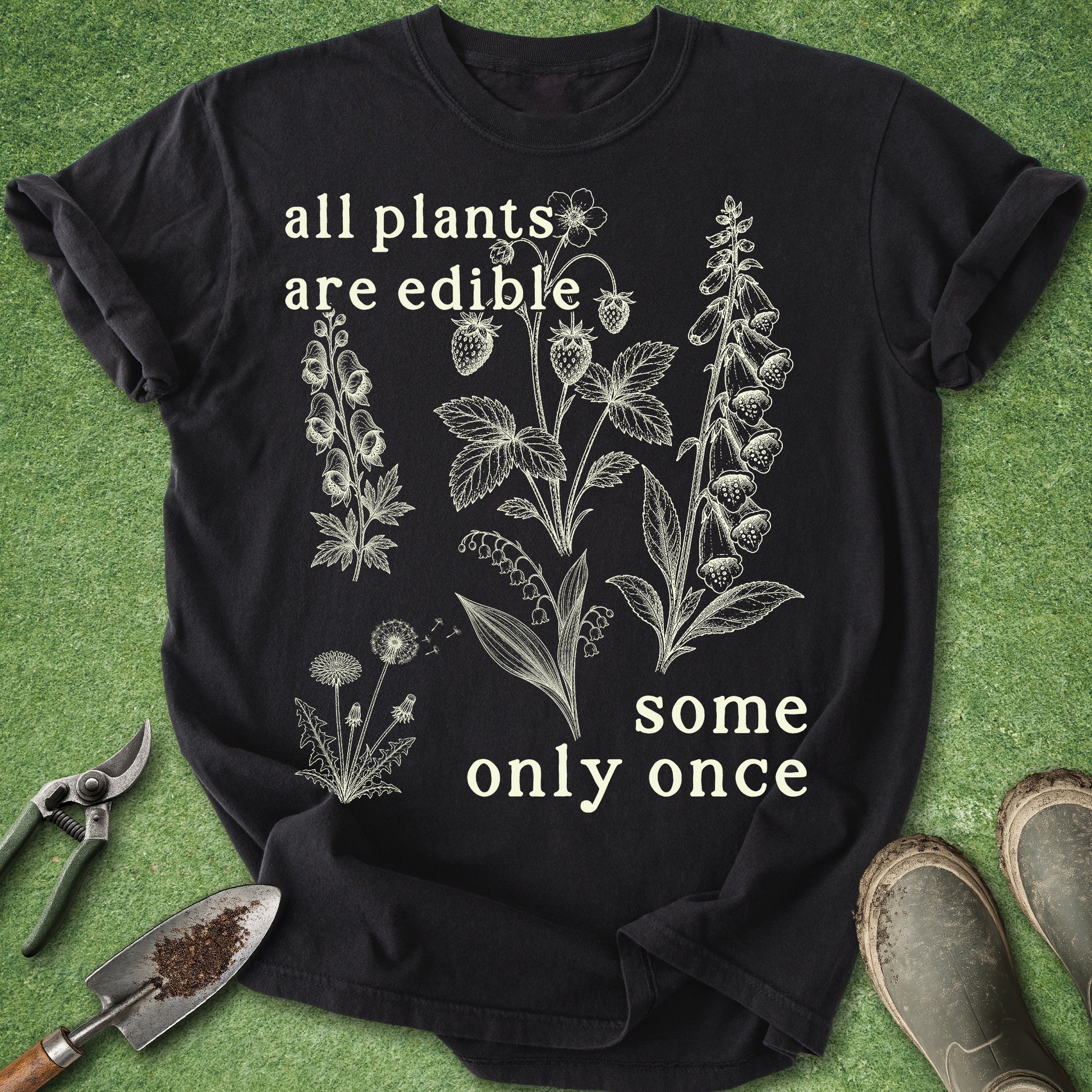 Black t-shirt with botanical designs and text on a green background