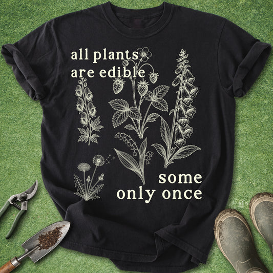 Black t-shirt with botanical designs and text on a green background