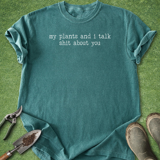 Comfort Colors Blue Spruce t-shirt featuring the funny quote "My Plants and I Talk Shit About You" in white vintage-style typewriter lettering.